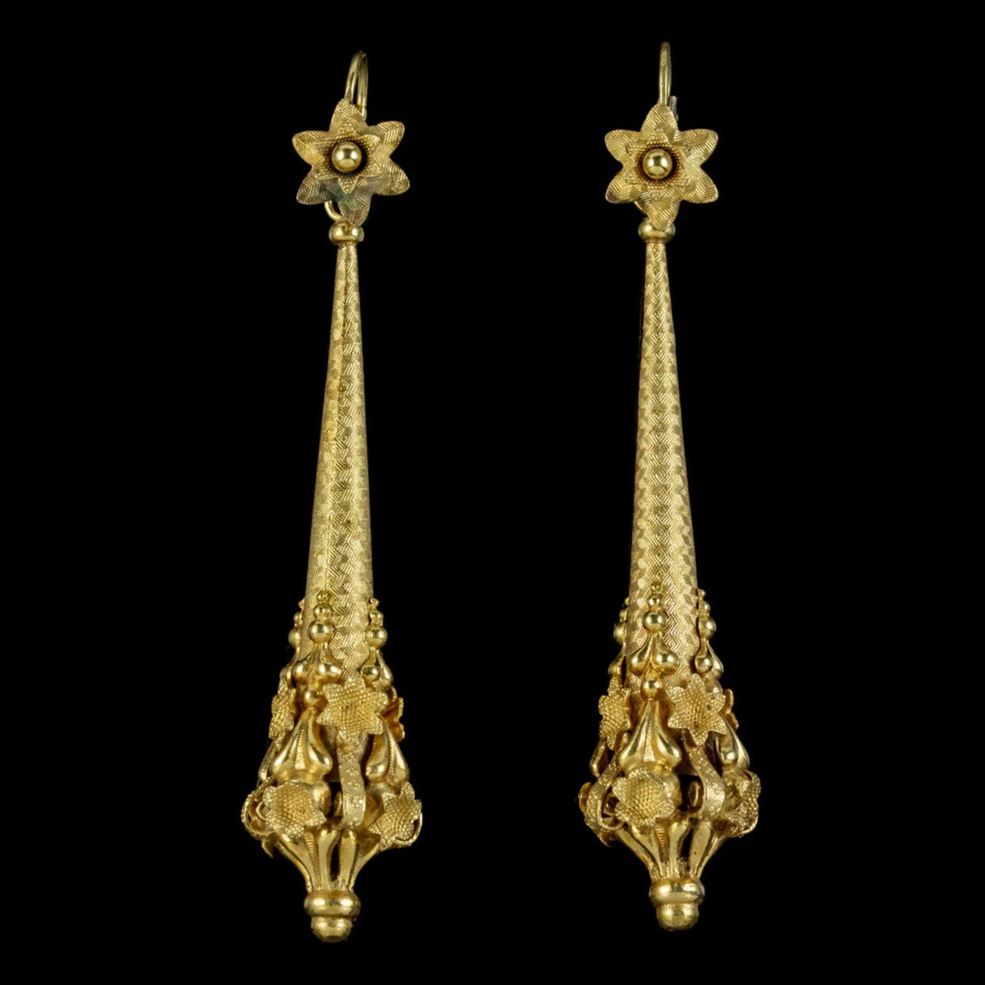 A spectacular pair of antique Georgian night and day earrings from the early 19th Century crafted in pinchbeck and gilded in 18ct yellow gold. 

The long droppers are chased with a fabulous chevron pattern and lead to ornate, cannetille metalwork at