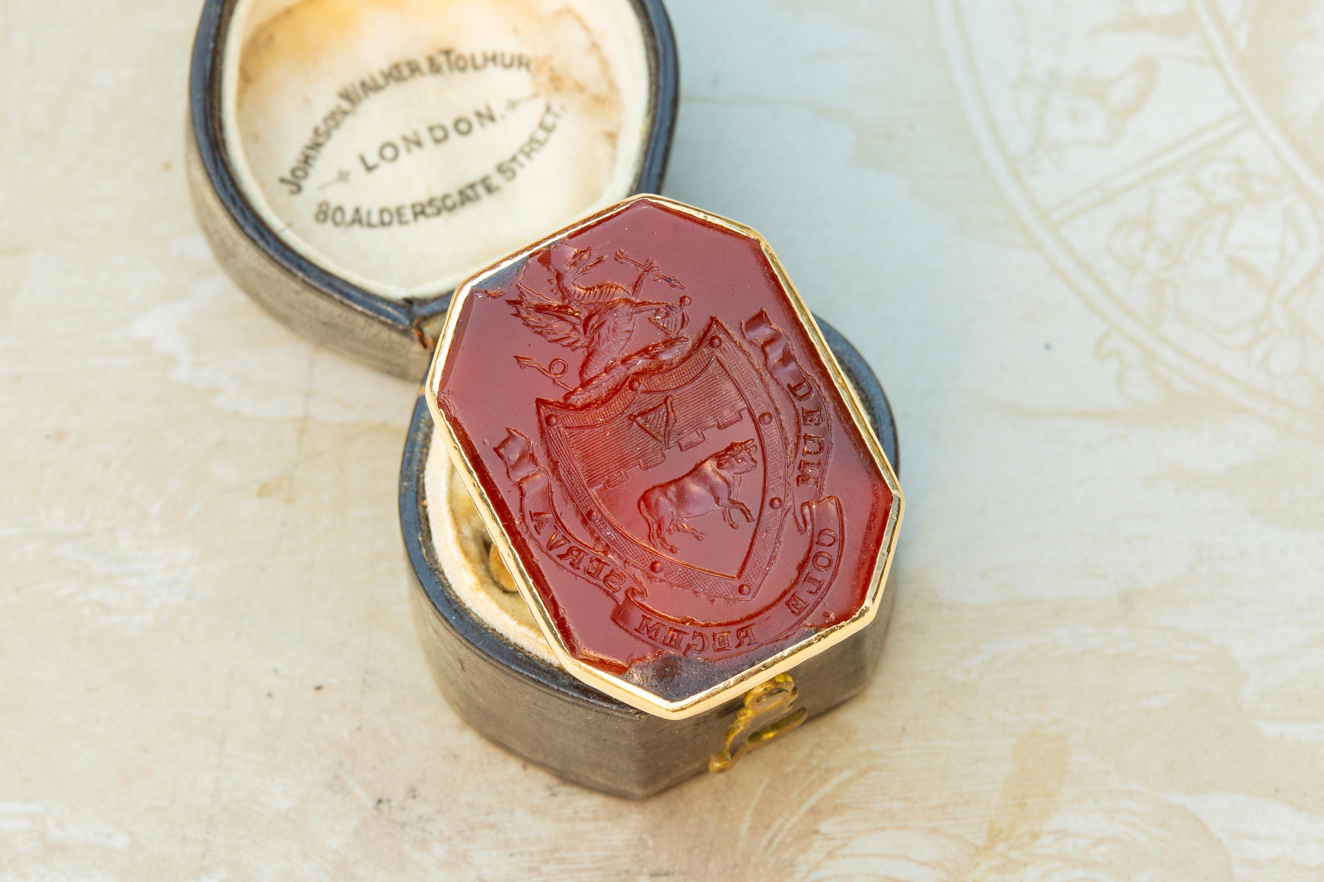 A large, heavy gold Irish noble signet ring, set with a carnelian intaglio depicting the coat of arms of the aristocratic Cole family. The stone would have originally been set into a large fob or desk seal, to be used for sealing deeds and important