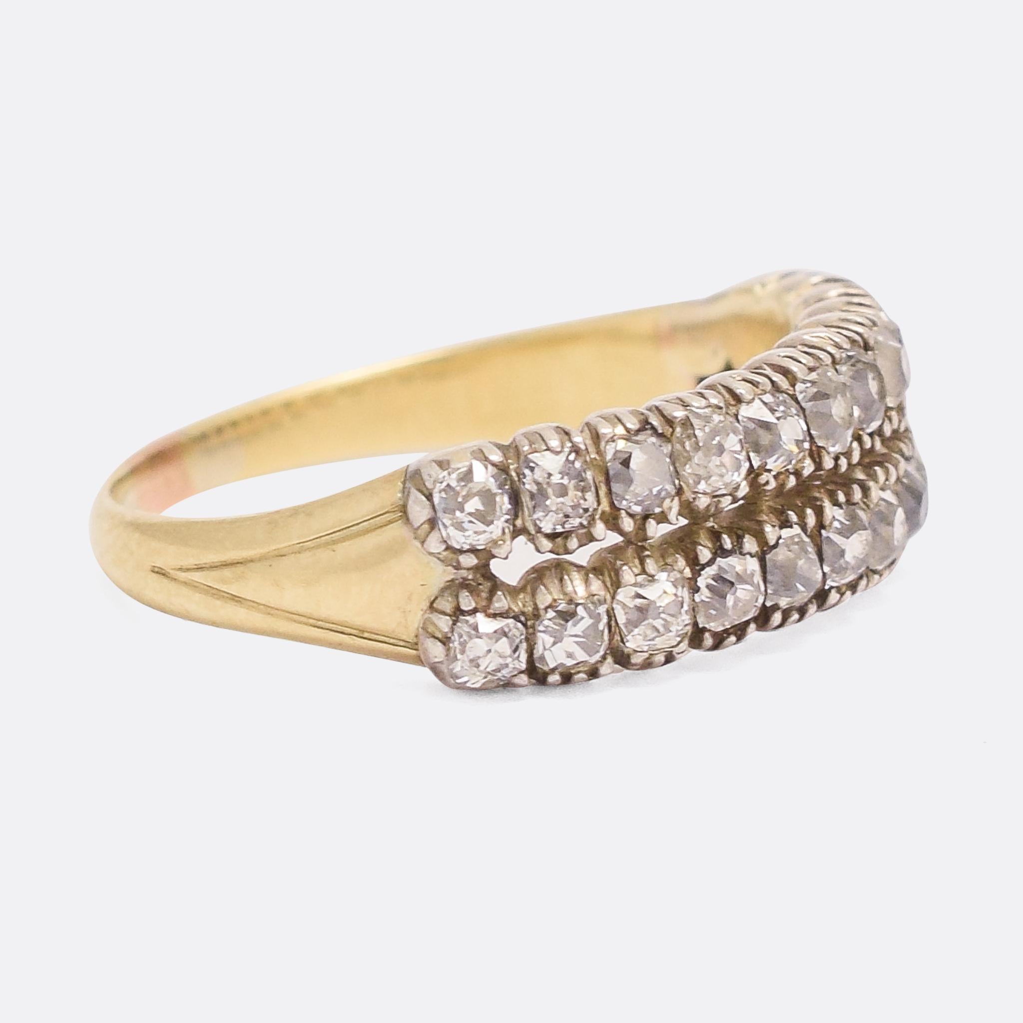 A superb Georgian diamond double row ring dating from the early 19th Century, circa 1820. The old mine cut stones rest in closed back silver pie-crust settings, while the band is modelled in 15 karat yellow gold. Home to over 1.1 carats of diamonds,