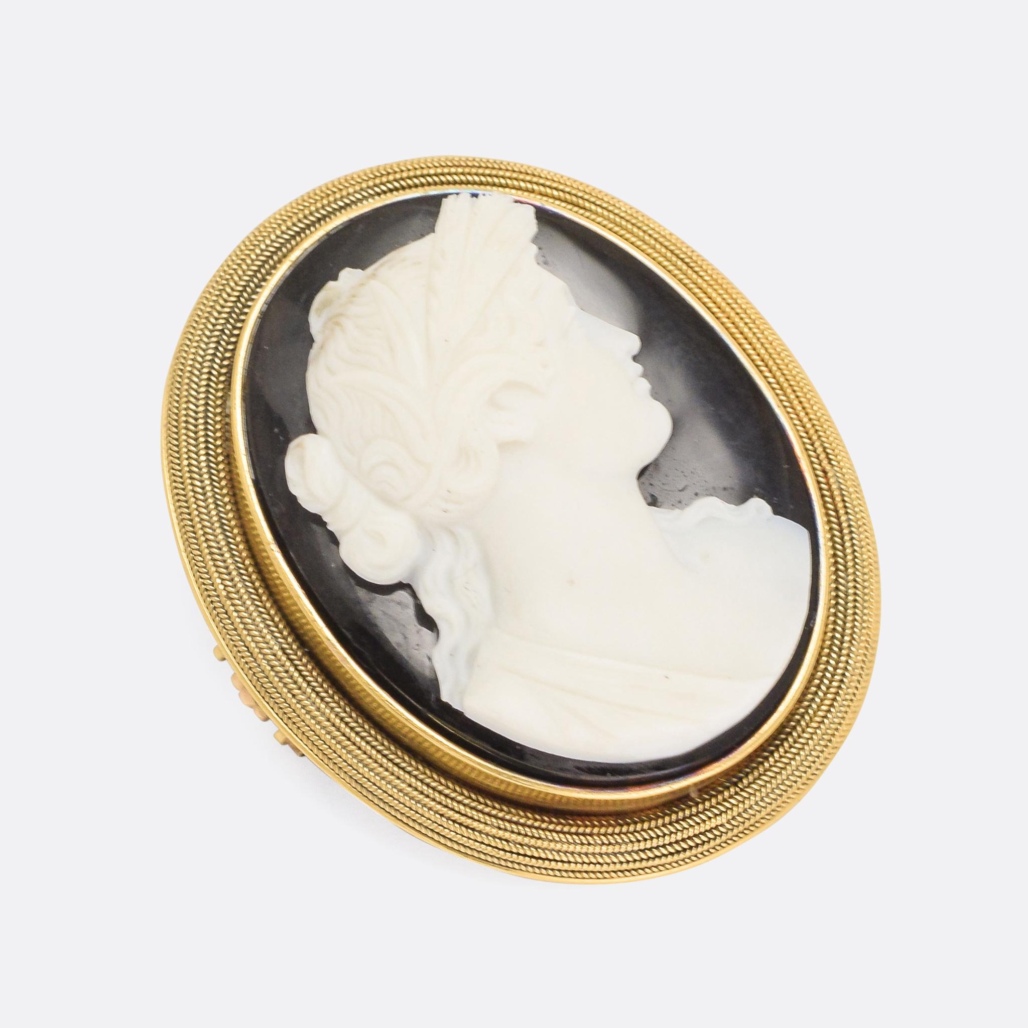 An exceptional onyx cameo brooch dating from the late Georgian era, circa 1820. The subject is a classical figure in profile, white against a black background, with excellent attention to detail. The cameo is set into a 15k gold frame which is