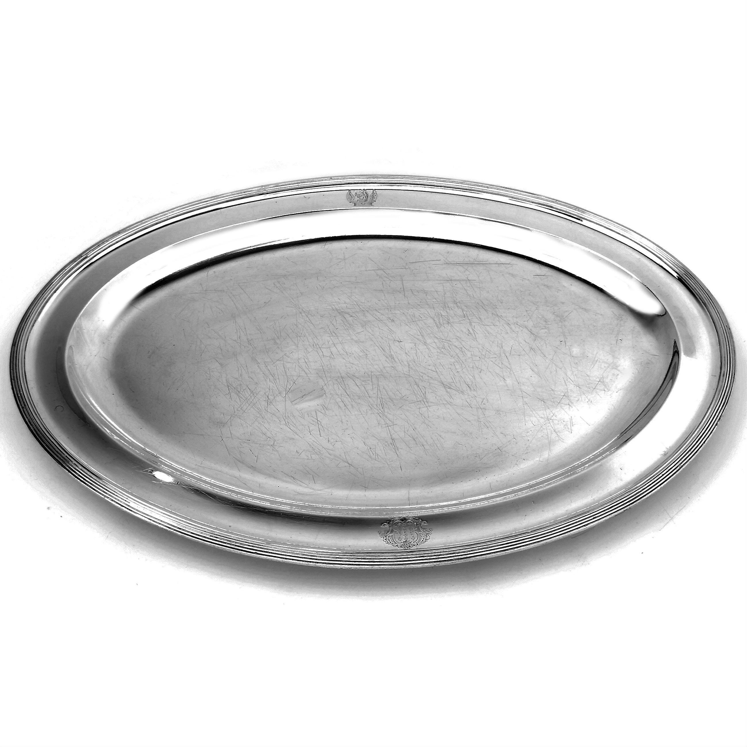 A Classic Antique George III solid Silver Meat Platter. This Georgian Meat Platter has a traditional oval shape with a elegant reeded border along the exterior edge. The rim of the Serving Platter has two small crests engraved with one on each of