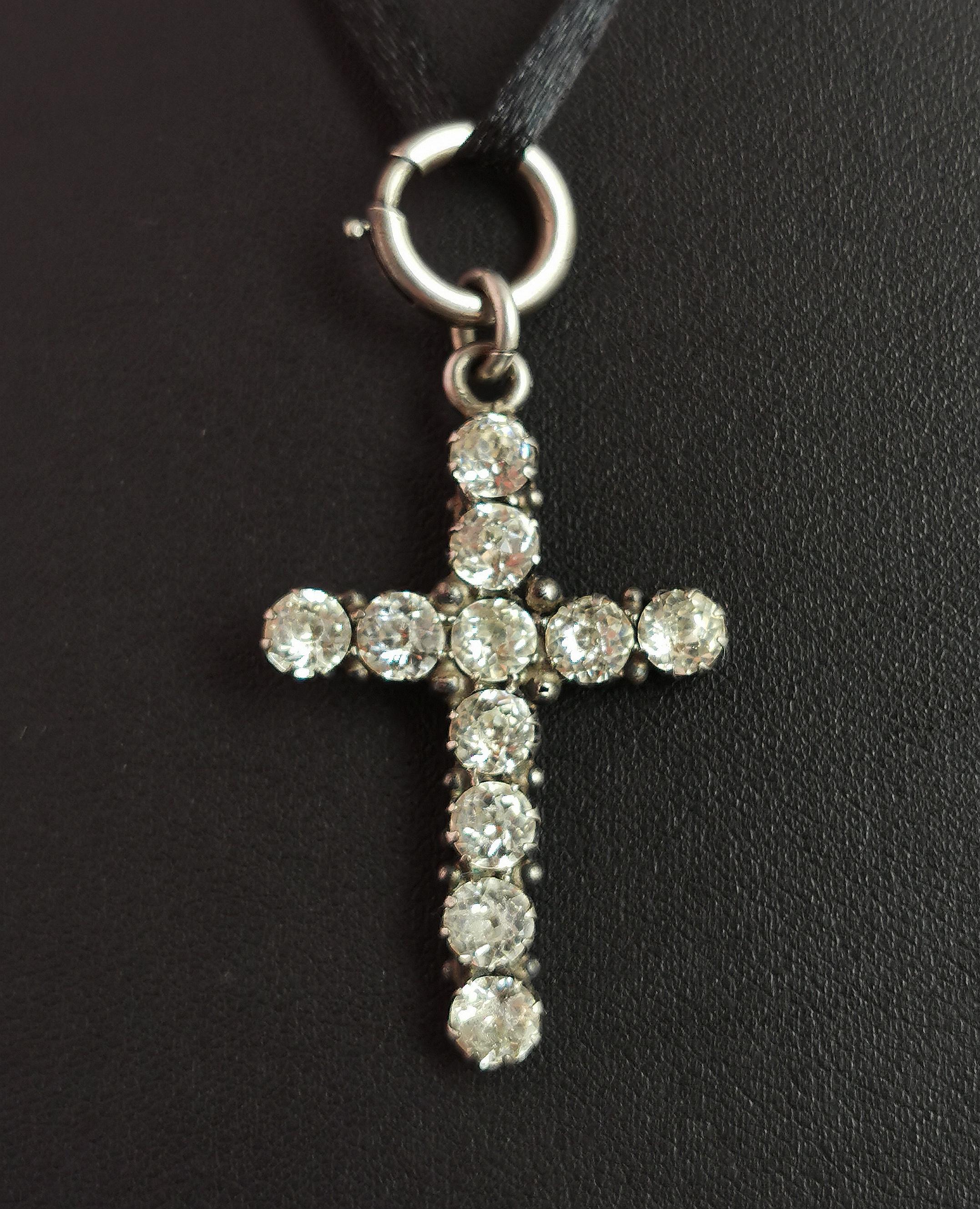 A beautiful antique, Georgian era paste Cross pendant.

A sterling silver cross adorned with old cut 'diamond' paste set into a foiled closed back setting.

The cross has had a large silver spring ring added making it perfect for adding to a neck