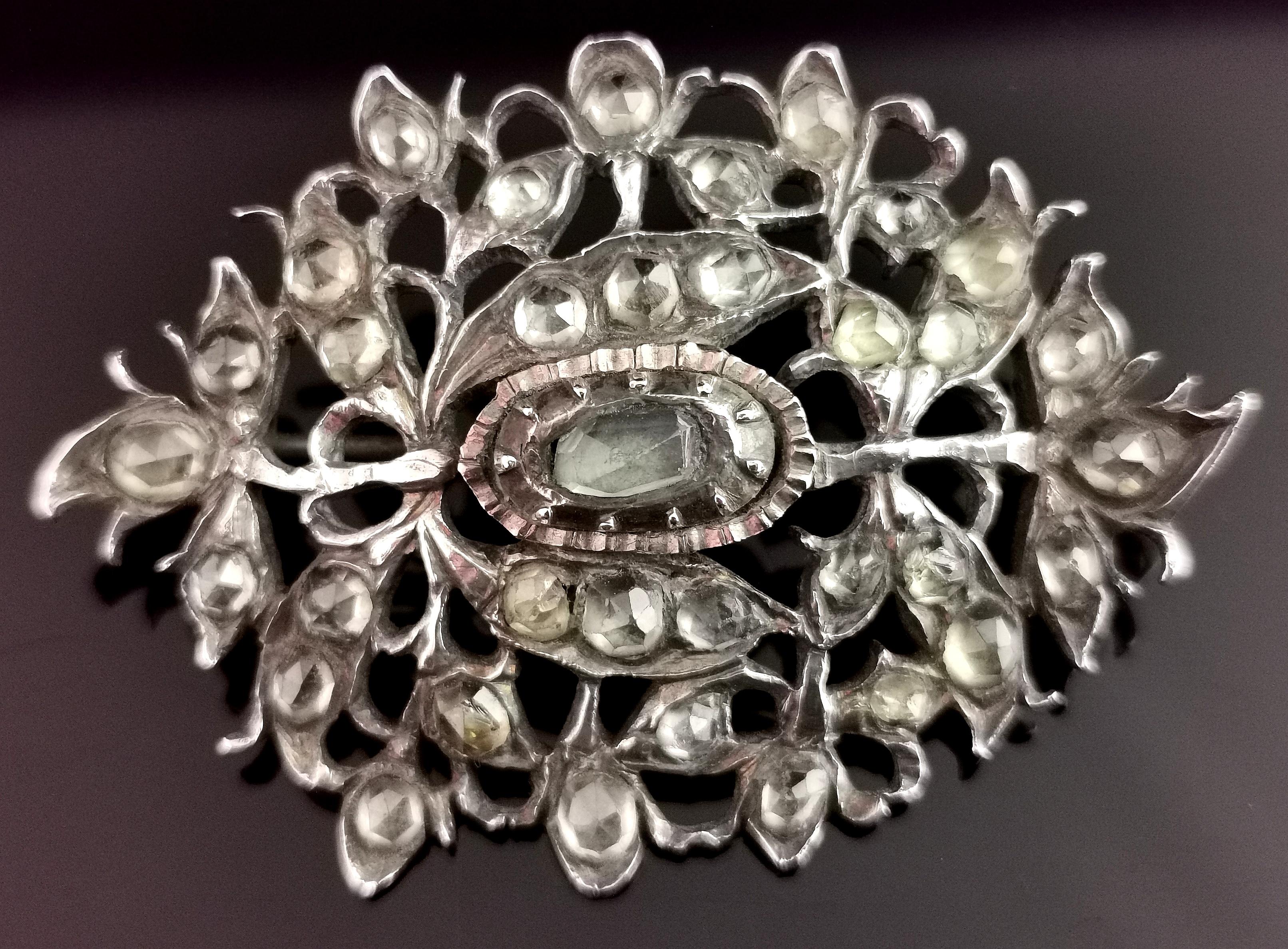 A beautiful antique Georgian floral spray brooch.

It is a large sized piece, suitable for securing a cloak or large shawl.

It has a floral openwork design with elements of the Iberian style and the early Giardinetti pieces, crafted in 800 silver