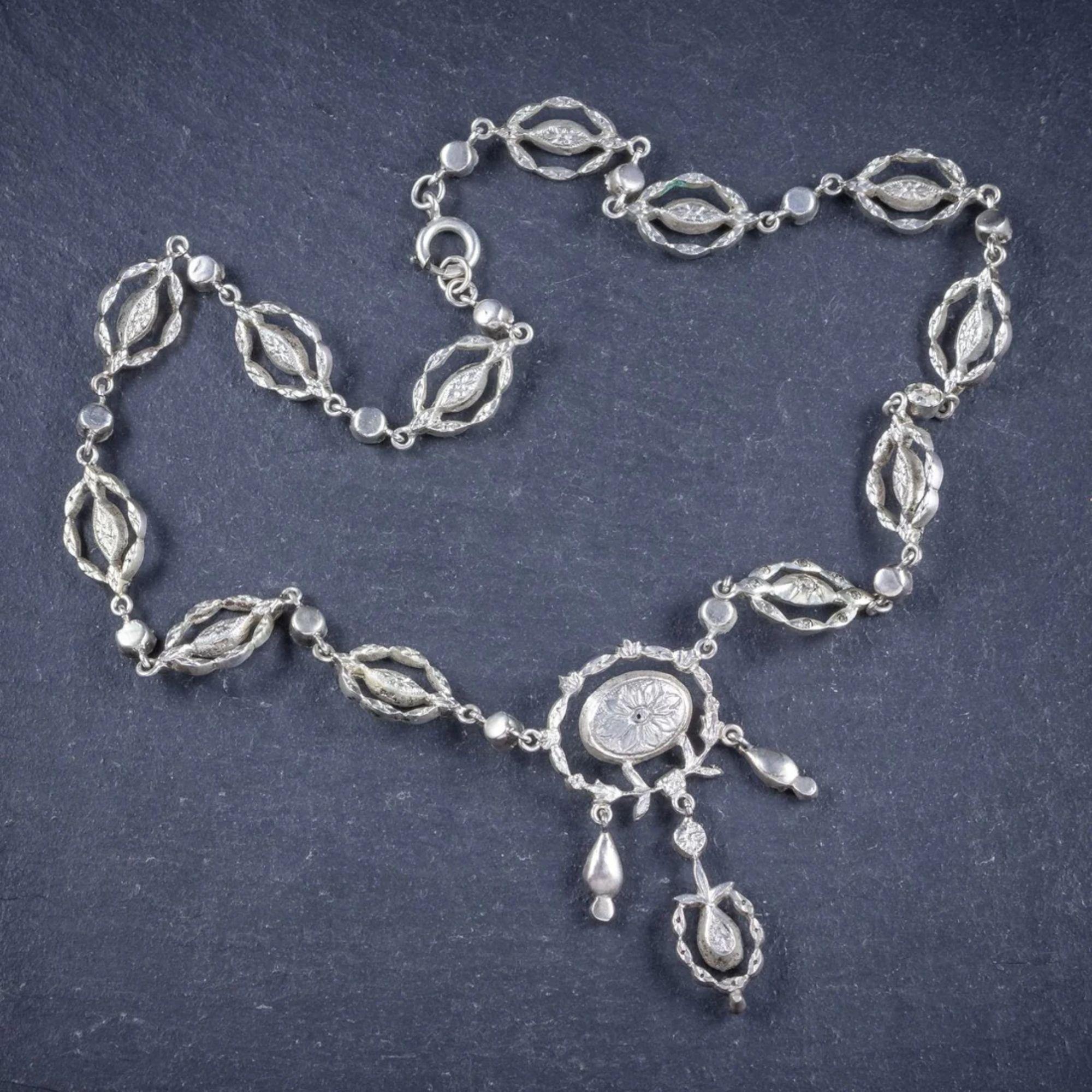 A magnificent antique Georgian lavaliere necklace decorated with fabulous, old cut paste stones that sparkle as bright as diamonds. The piece is all silver and made up of pretty, open-work links that lead to a beautiful dropper pendant. 

A