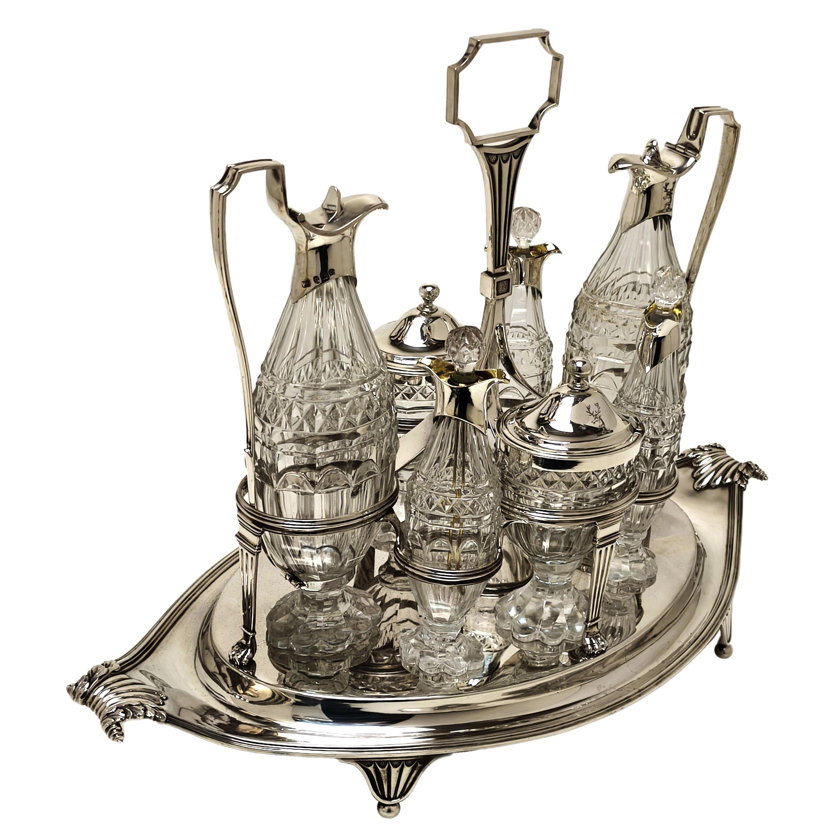 A magnificent Antique George III Sterling Silver Cruet Stand with a set of 8 Silver & Cut Glass Condiment Containers. This Large Antique Silver Condiment Stand includes a pair of Mustard Pots, and Pair of Oil & Vinegar Bottles and 4 smaller