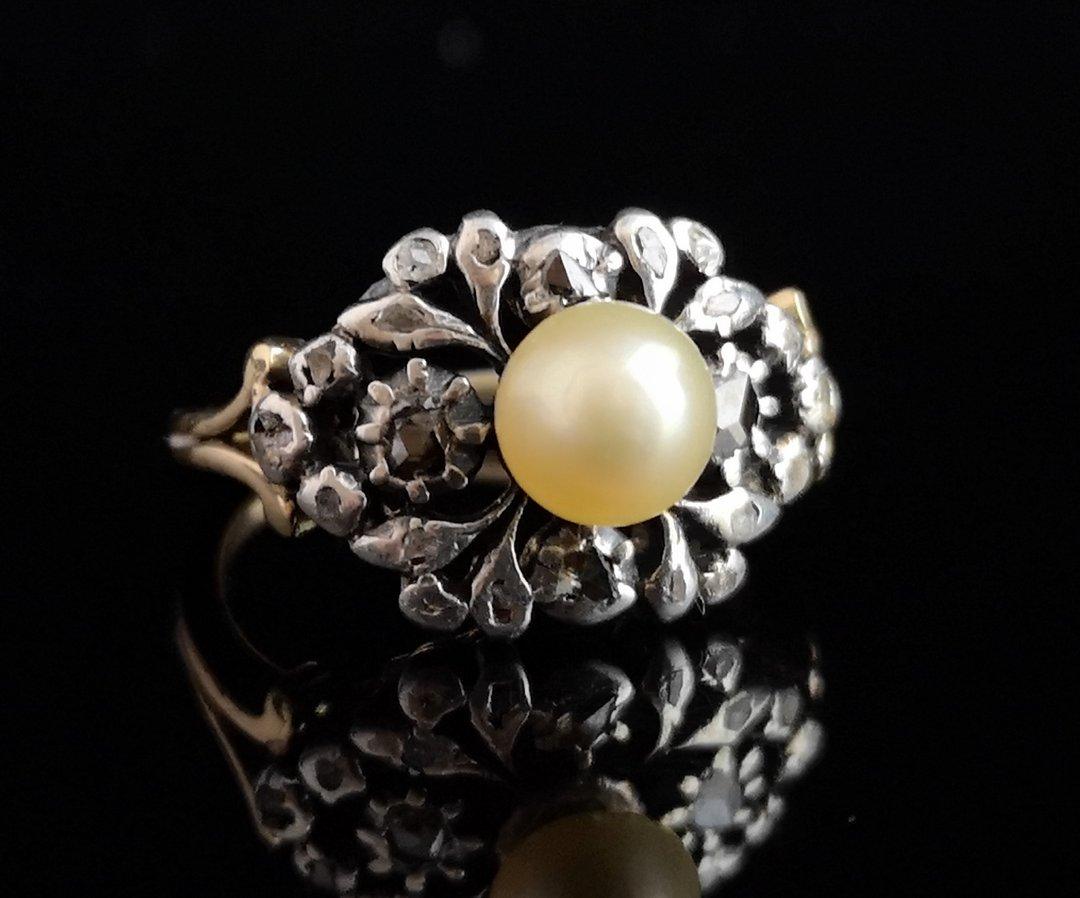 A beautiful and unusual antique, Georgian diamond and pearl ring.

It has a large front panel of scrolling silver set with over 22 Georgian rose cut diamonds, there are two larger diamonds either side of the pearl and many small ones set all around