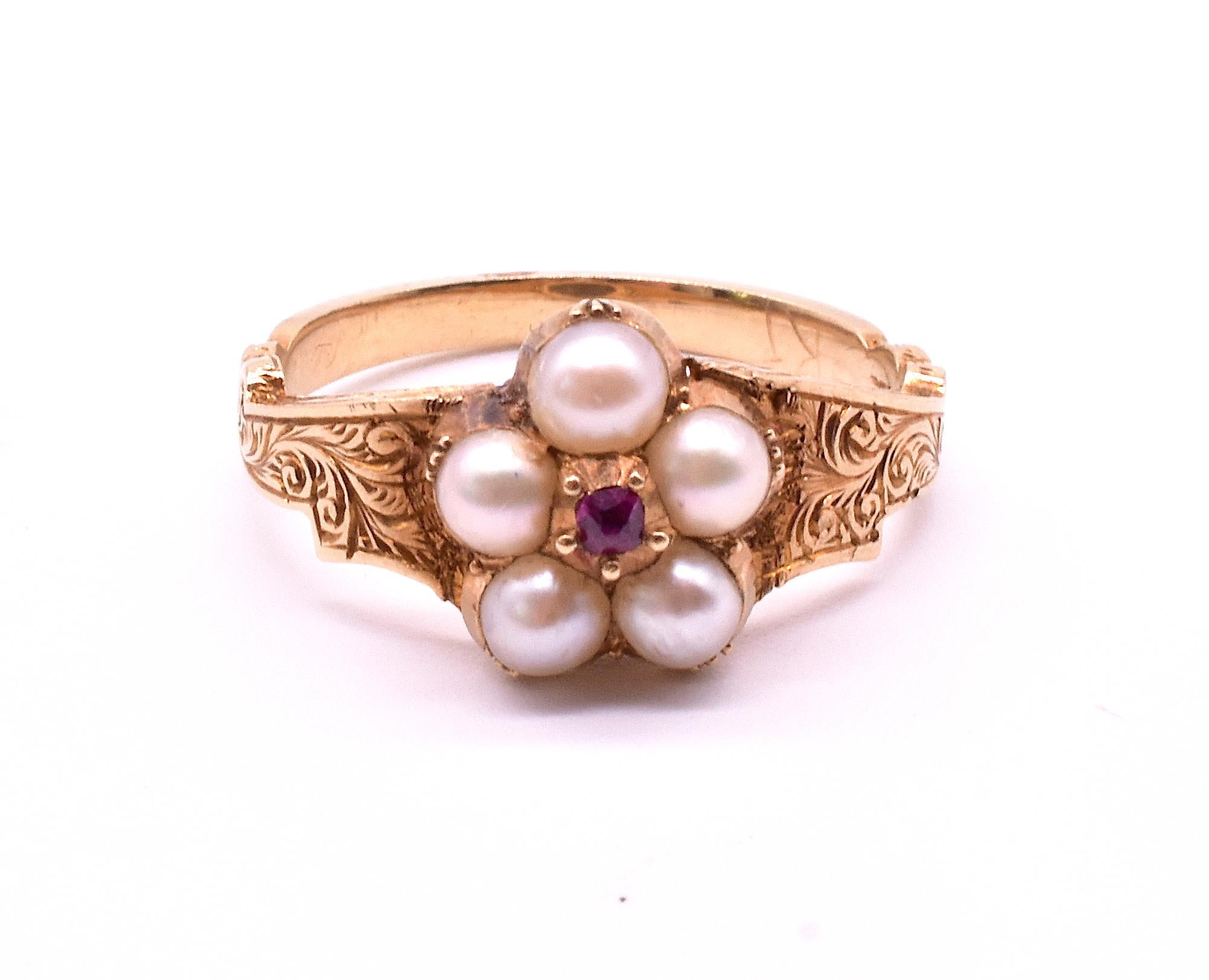 18K pearl forget me not ring with  five well matched natural white pearls in a forget-me-not arrangement with a center ruby, is awash in sentiment. The pearls indicate remembrance We love this delicate sentimental ring with its ornate band