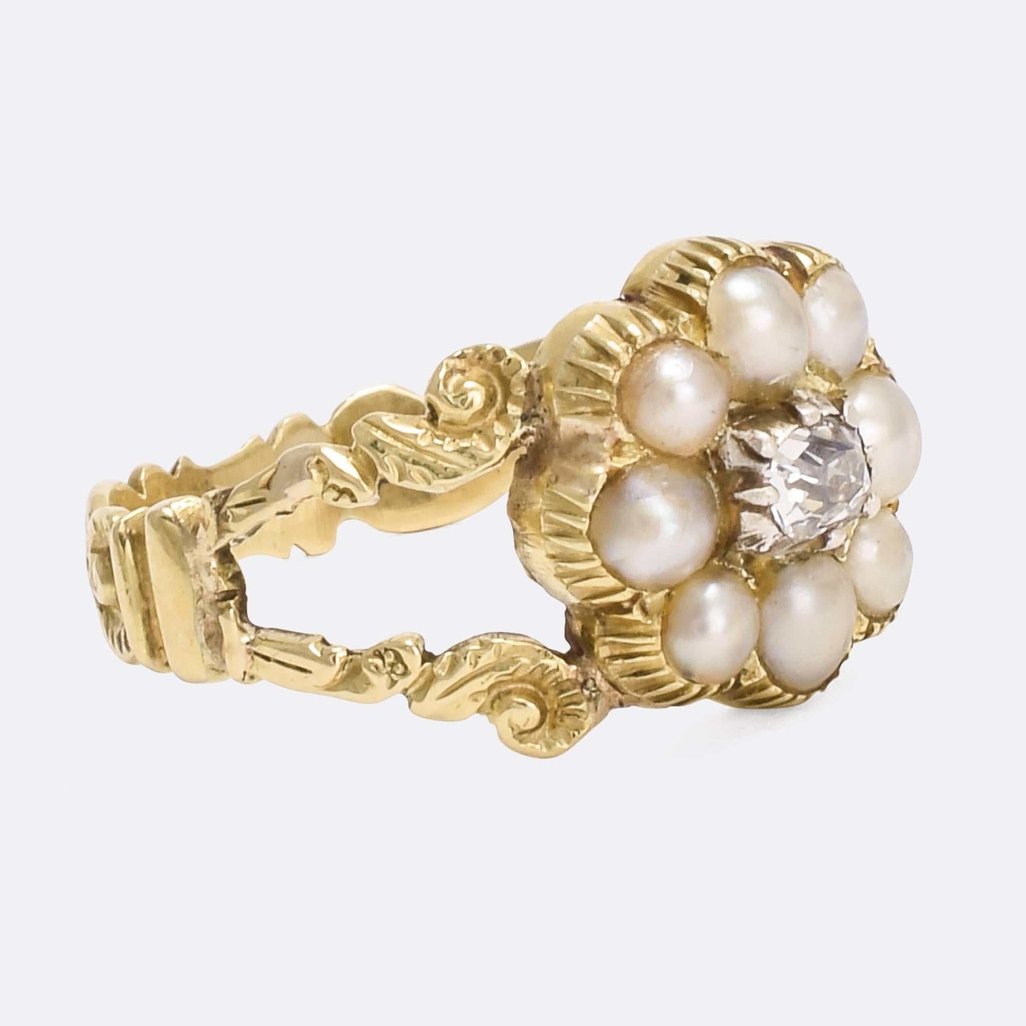 A beautiful antique cluster ring set with white pearls and an old mine cut diamonds. It's modelled in 15 karat gold throughout and was made in England circa 1820. With elegant split shoulders and hand-chased foliate band.

STONES 
Natural Pearls and