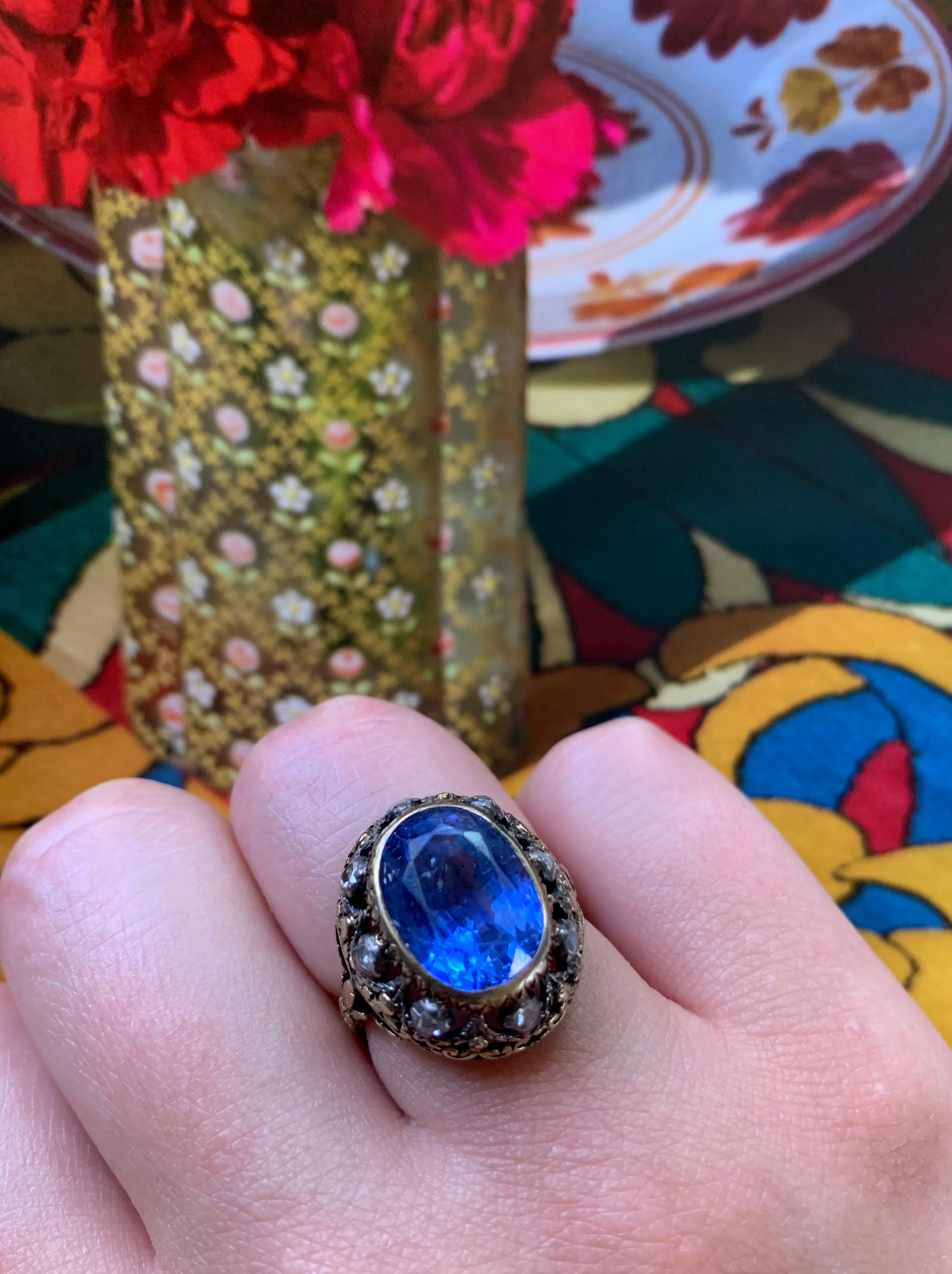 Exceptional natural color change sapphire and rose cut diamond Georgian Period ring.
The sapphire of Sri Lankan origin, lively blue color changing to violet, approximately 8 carat, measuring 12.63 x 9.08 x 7.52mm, surrounded by eight near colorless