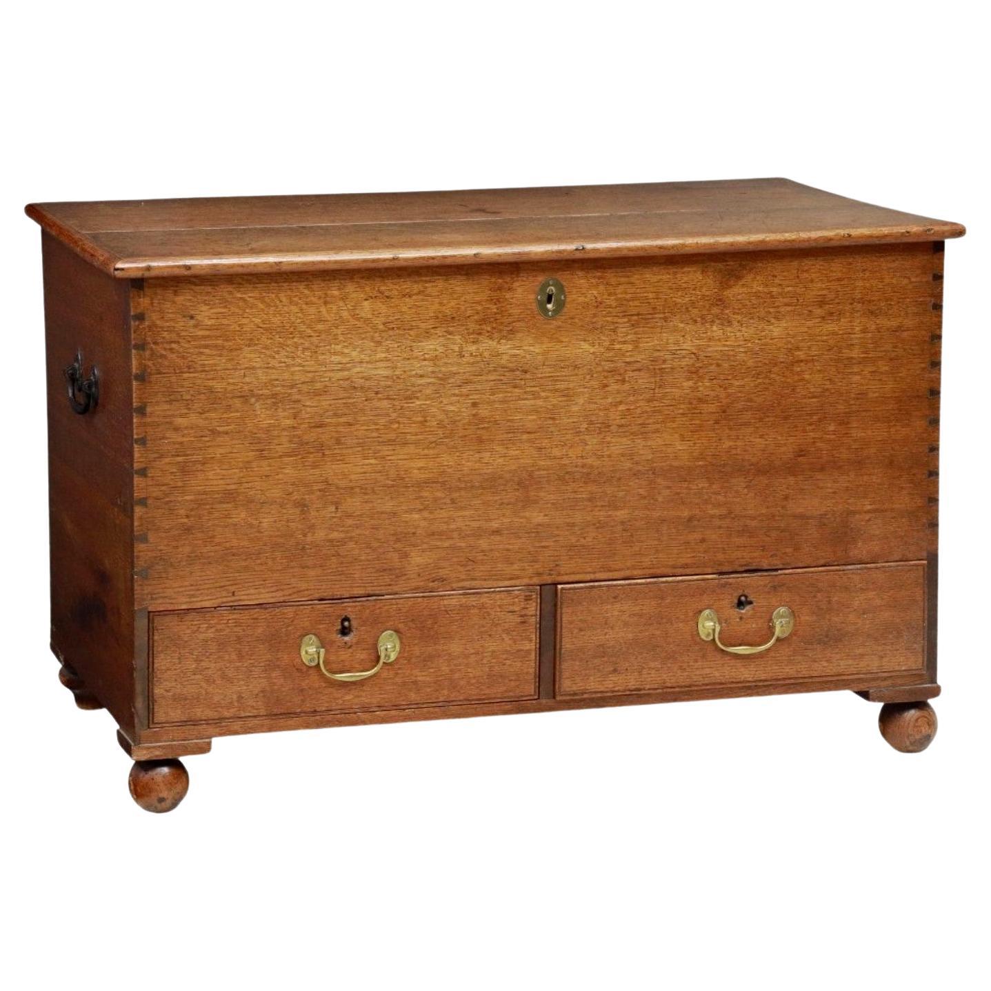 A Georgian era (1714-1837) English oak mule chest.

Born in the late 18th / early 19th century, during the reign of King George III (1760-1820), fine quality craftsmanship and construction, hand-crafted of warm rich solid oak, used to store clothing