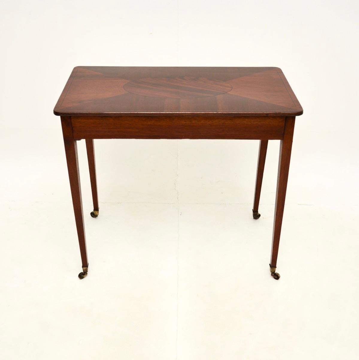 A smart and unusual antique Georgian period writing / side table. This was made in England, it dates from around the 1800-1810 period.

It is of very fine quality, the rectangular top has inset flame veneers and ebony borders. It stands on