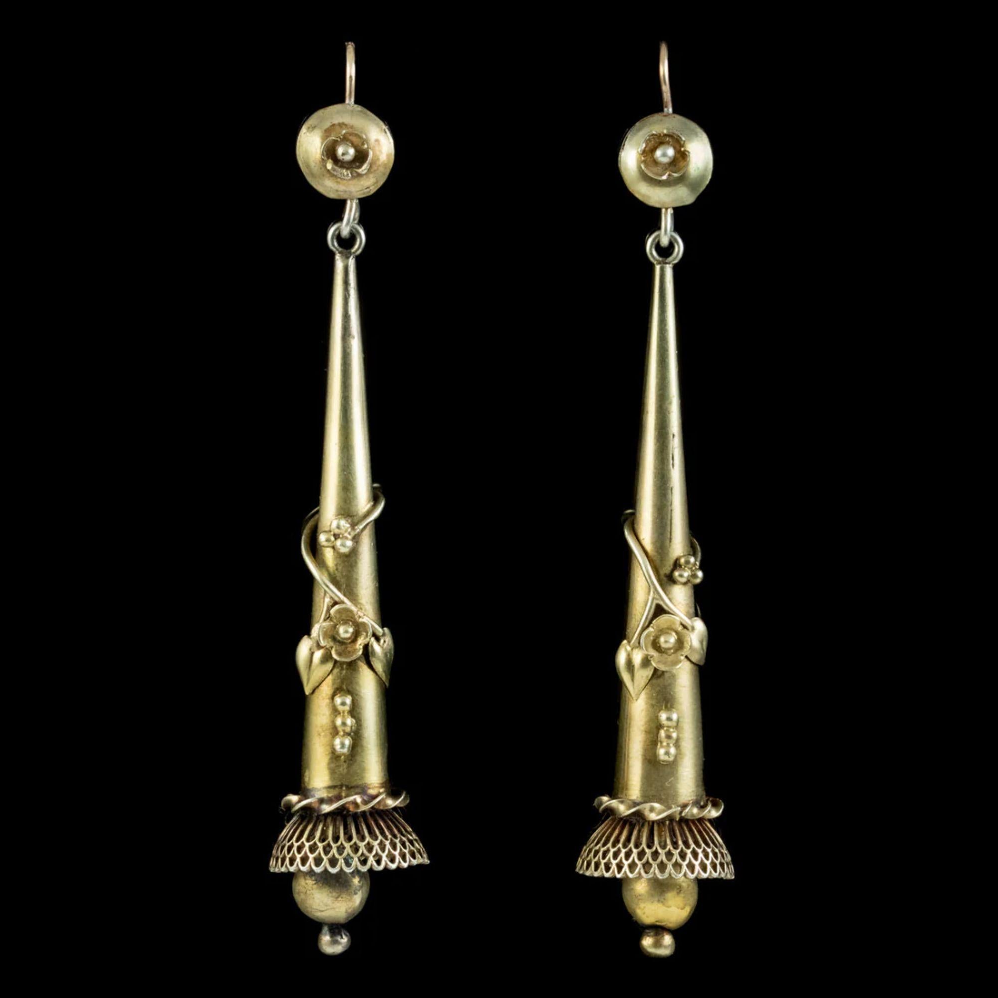 A grand pair of Antique Georgian drop earrings from the early 19th Century. Both feature beautiful floral metalwork wrapping around each long dropper leading to an ornate, fringe below with a golden ball dropper. 

Both earrings are modelled in