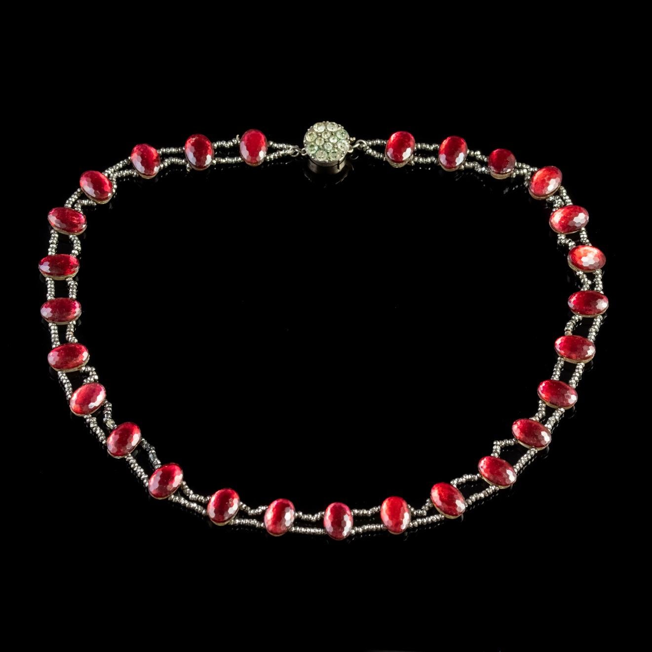 An exquisite antique Georgian collar made up of bold red Paste Stones with geometric facets across the surface allowing the stones to shimmer in the light.  

Paste is a heavy, transparent flint glass that simulates the fire and brilliance of