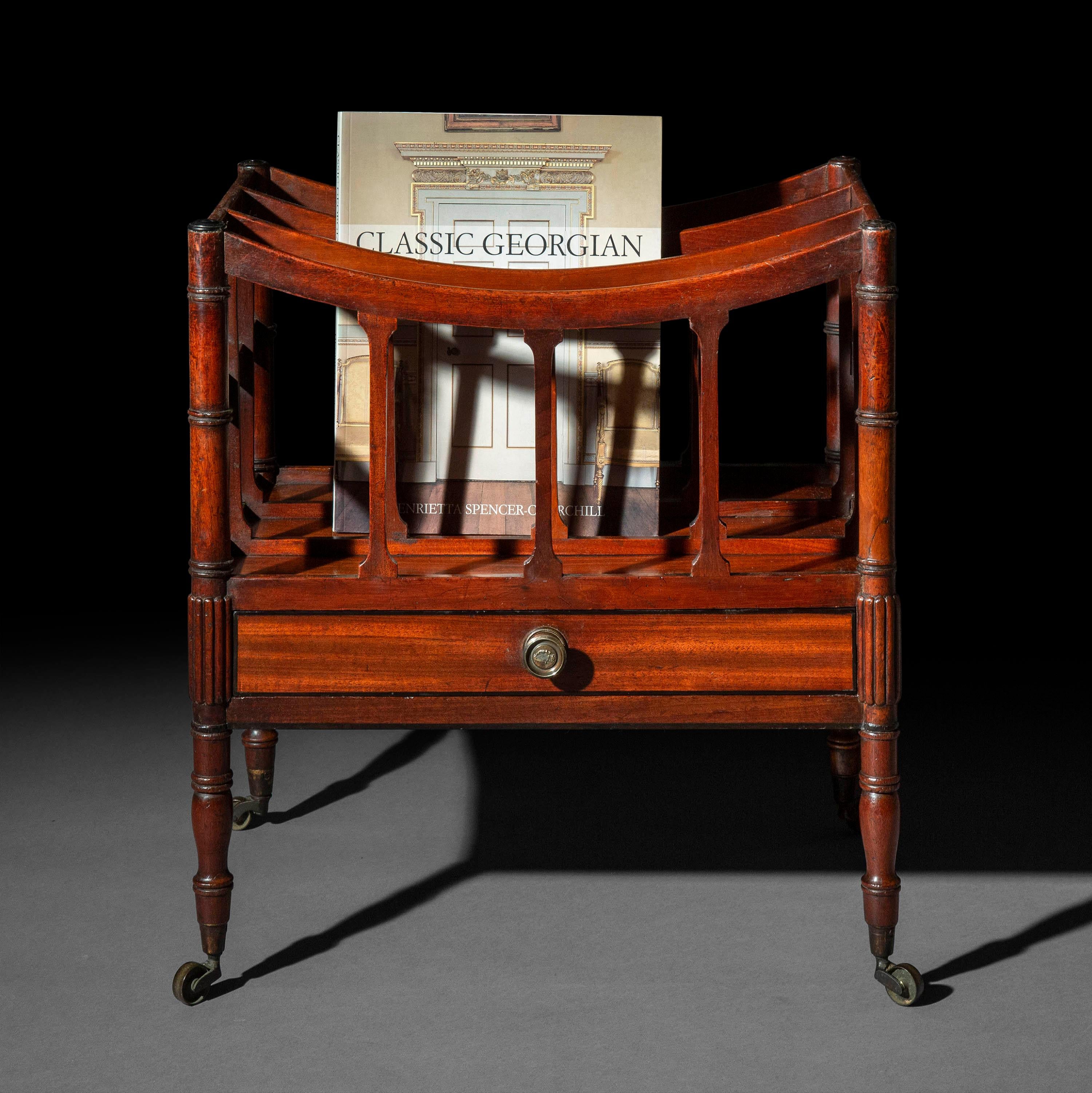 An interesting late Georgian – early Regency canterbury or magazine stand,
England, circa 1800.

We like the unusual faux-bamboo and black-highlighted details, the rich patination and beautiful colour, and a most delightful original brass knob with