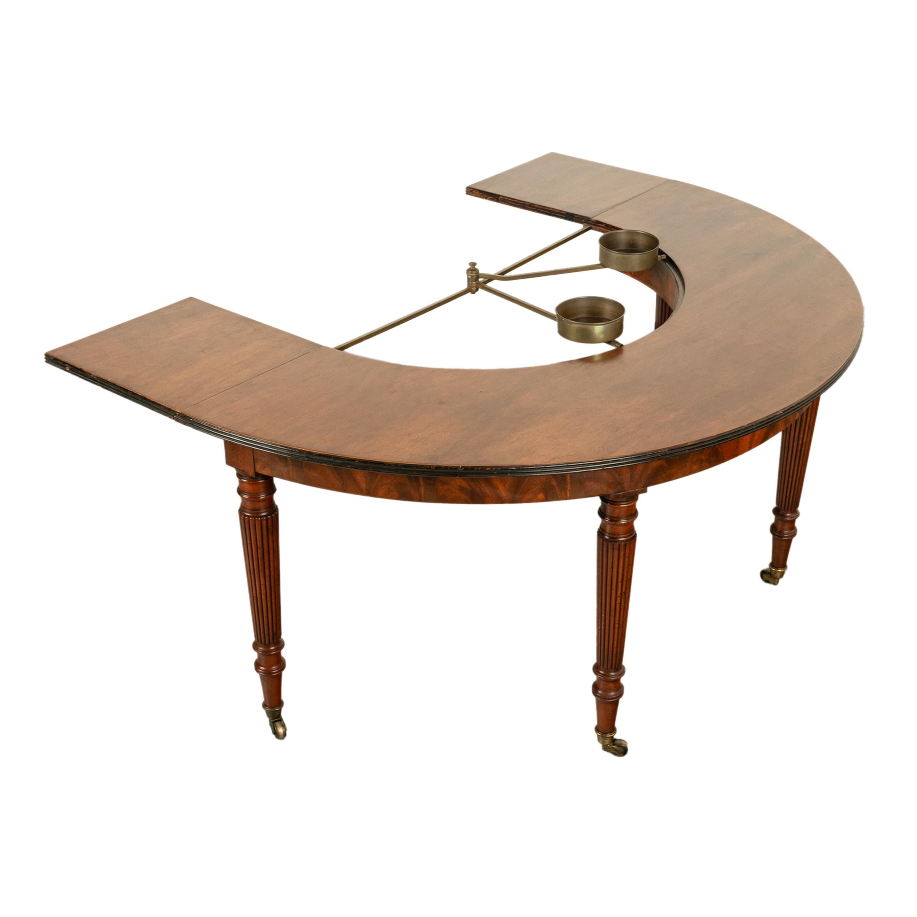 A very good antique Regency flame mahogany wine, hunt or social table, in the manner of Gillows of Lancaster, Circa 1820. 

Of typical horseshoe form with both leaves extended and of crescent form with leaves down, the leaves are hinged & are