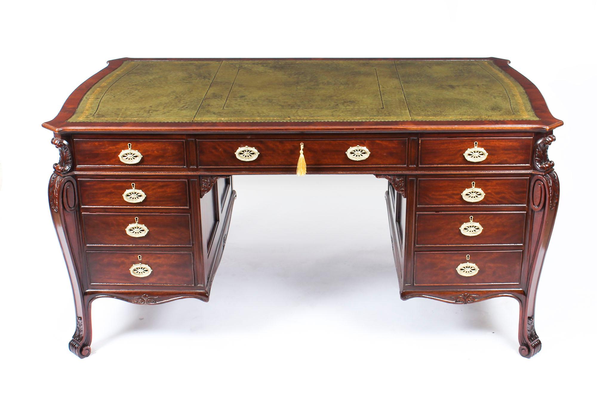 This is a stunning Georgian Revival mahogany partners pedestal desk, circa 1880 in date.
 
The desk features an inverted shaped rectangular top with an inset olive green gold tooled leather above a frieze with three drawers.

The acanthus moulded