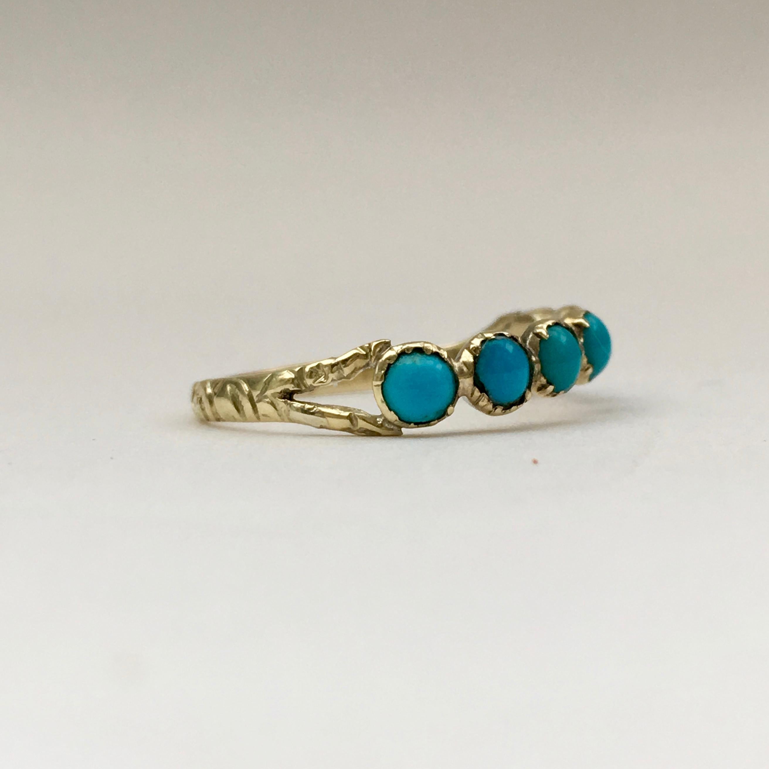 Turquoise is one of the oldest stones and has been used in jewellery throughout history. This delicate half eternity band ring is a lovely example that dates from the Georgian era. The split shank is engraved with a foliate design, and the collet