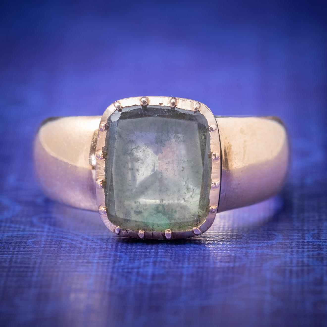 A grand antique Ring from the Georgian era adorned with a foil backed Rock Crystal which is a clear colourless form of Quartz that is highly durable and once believed by ancients to be a form of solidified ice that could never be thawed. The stone