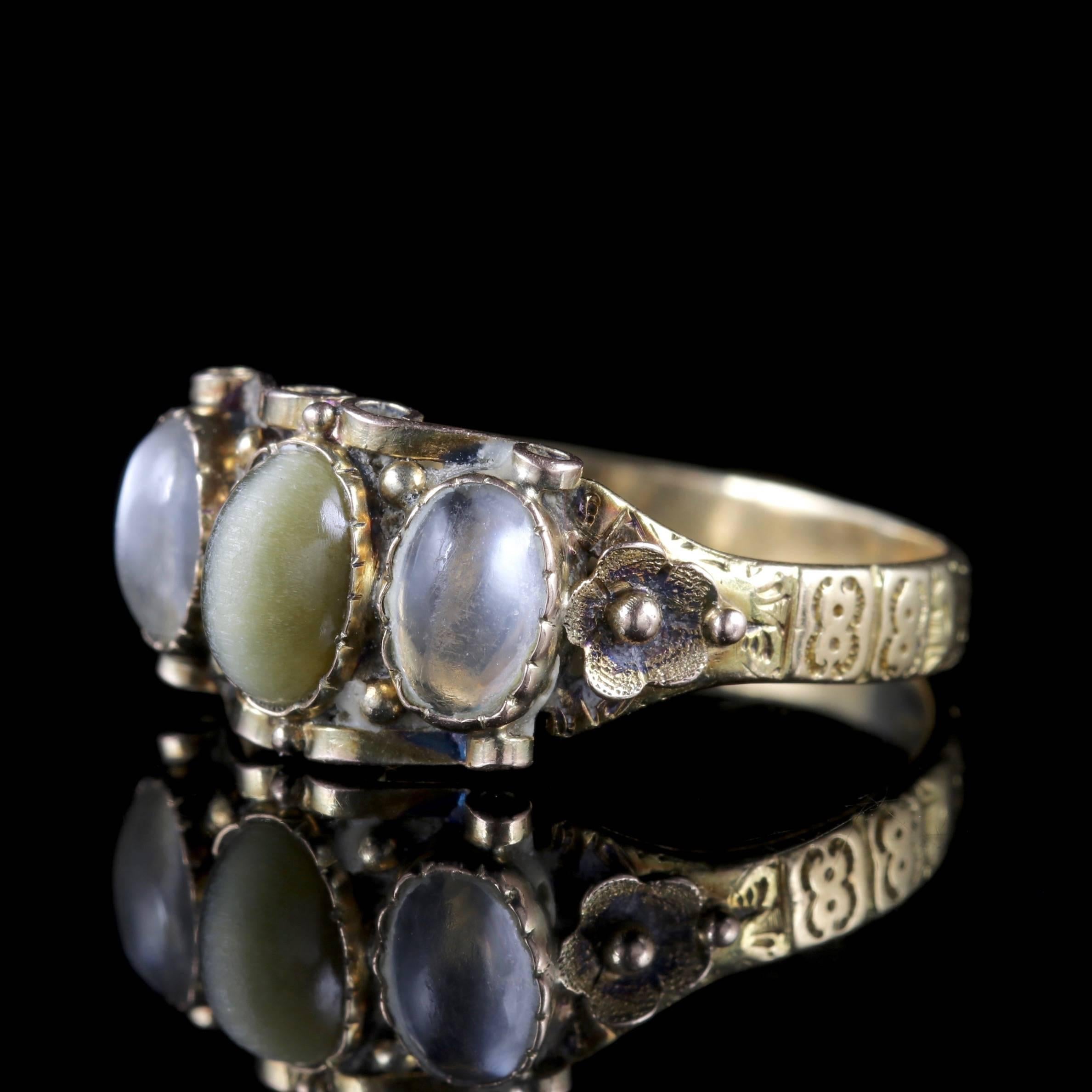 To read more please click continue reading below-

This stunning antique 18ct Gold Georgian ring boasts a trilogy of beautiful gemstones, Circa 1830. 

The wonderful ring is adorned with a central green Cat’s eye stone with two glowing Moonstones at