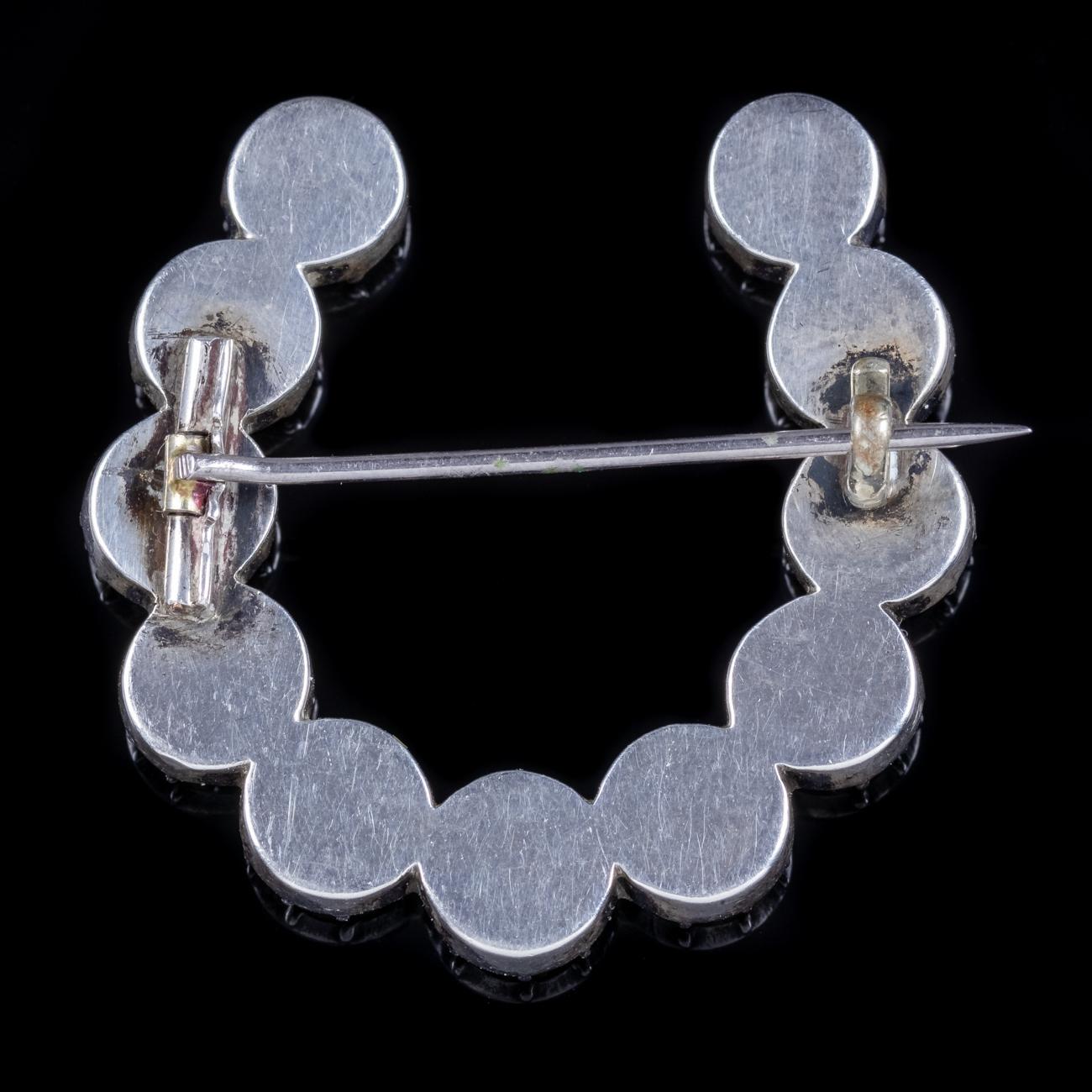 A lovely antique Georgian Horseshoe brooch C. 1800 adorned with eleven old cut Rock Crystal stones that sparkle like Diamonds. The beautiful clear Rock crystal is a colourless form of Quartz that was once believed by ancients to be a form of