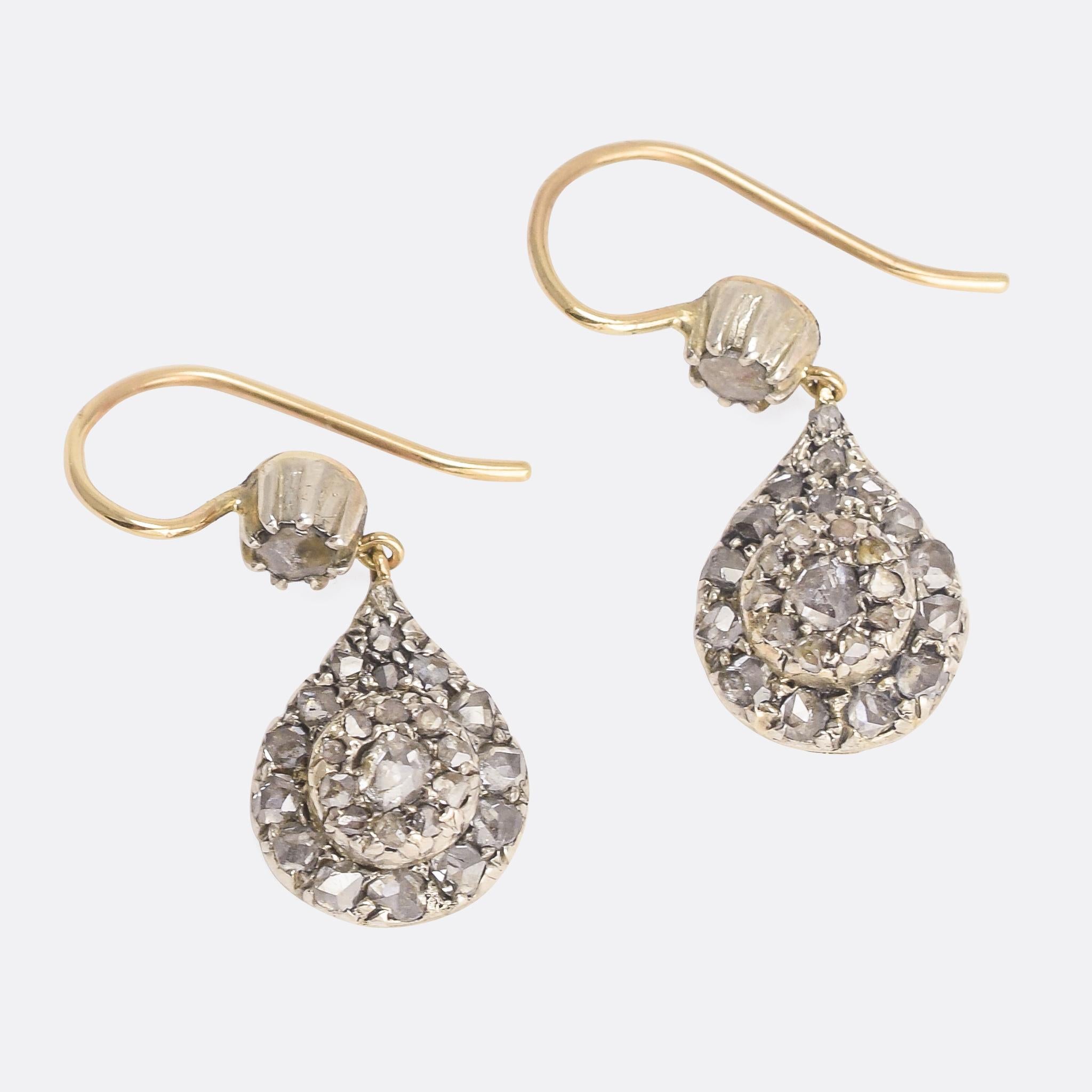 A gorgeous pair of antique teardrop earrings. The drops are pavé set with rose cut diamonds, and hang from diamond-set tops. They're a great size, a little over 1 inch drop, and a particularly elegant design. They were handmade in the early 19th