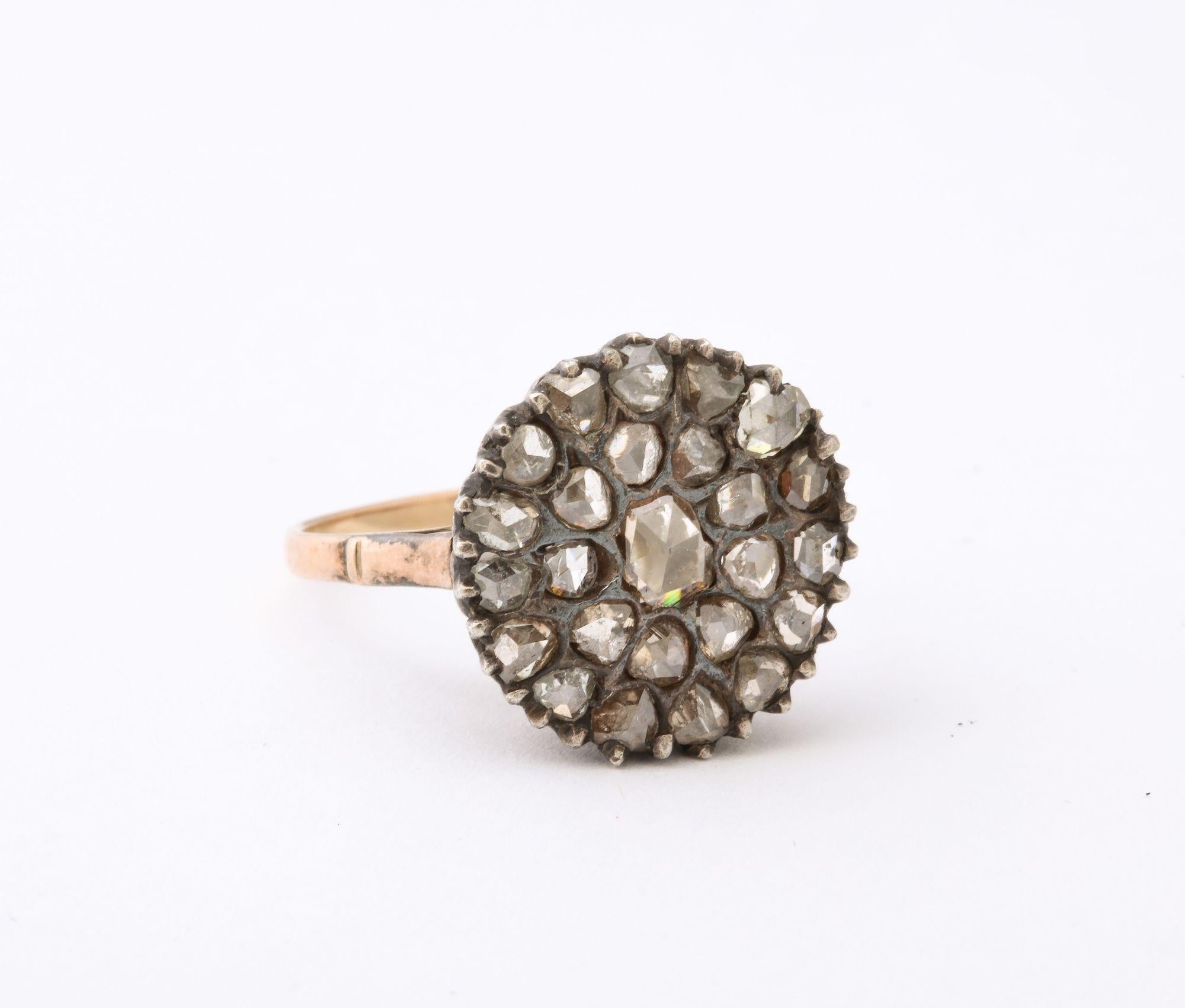 Antique Rose Diamond and Gold Ring. A classic period antique ring with a central rose diamond surrounded by a cluster of smaller rose diamonds on a 10K Gold mount. Approx 1.5 carat weight. Color K-M