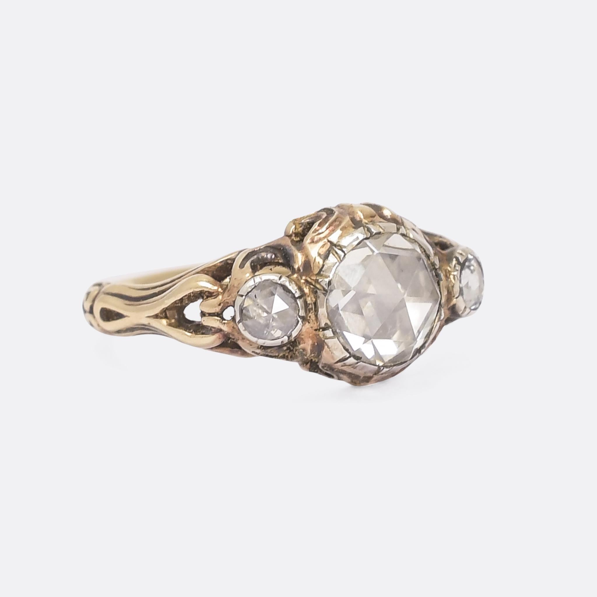 The most incredible Georgian rose cut diamond three-stone ring dating from the early 19th Century, circa 1800. The diamonds are highly domed, bright, and beautifully cut, resting in foil-backed cut down silver settings that reflect the light back
