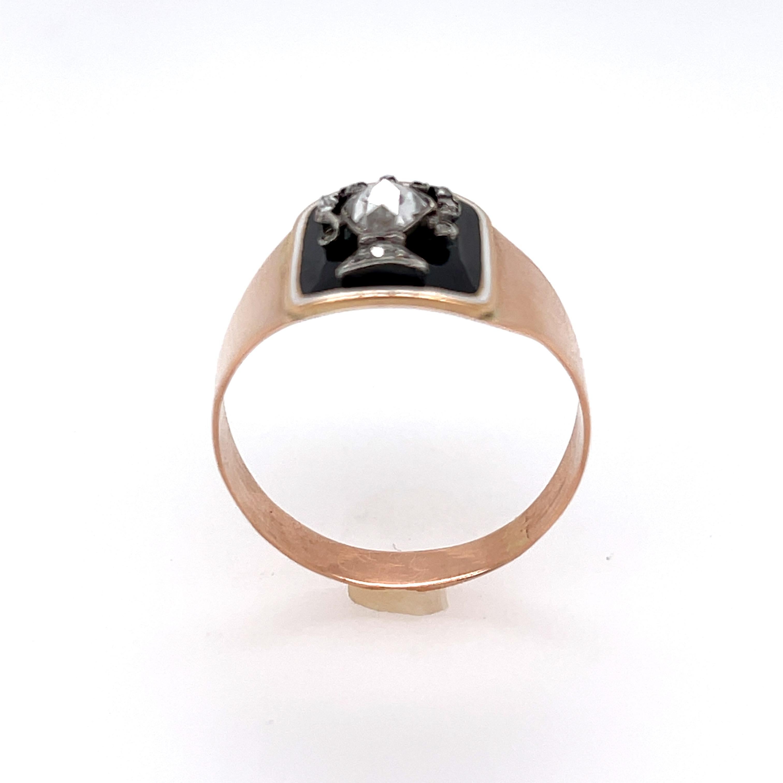 An antique rosecut diamond enamel memorial ring made in 14k yellow gold dated 1798. The ring is an attractive thin band that has a plaque on top with black enamel and set with a pear shape rosecut diamond that is styled as an urn. It is a sleek and