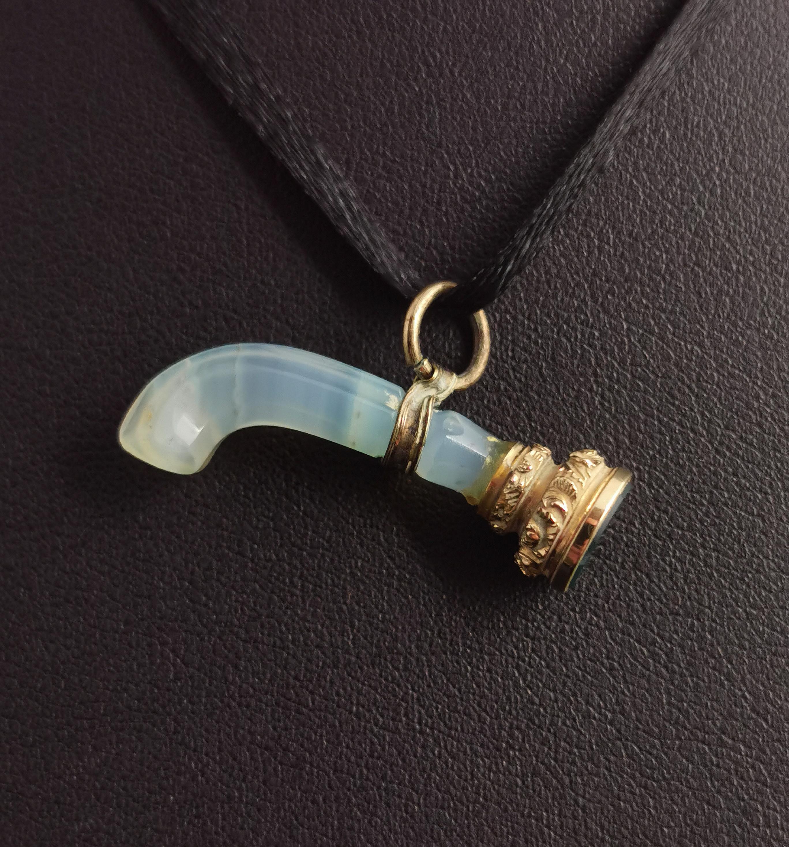 A beautiful, rare and unusual antique, Georgian era agate seal fob pendant.

The pendant is designed as a miniature desk type seal carved from a pale blue / grey agate, it has a small white metal collar which holds a jump ring to be worn as a