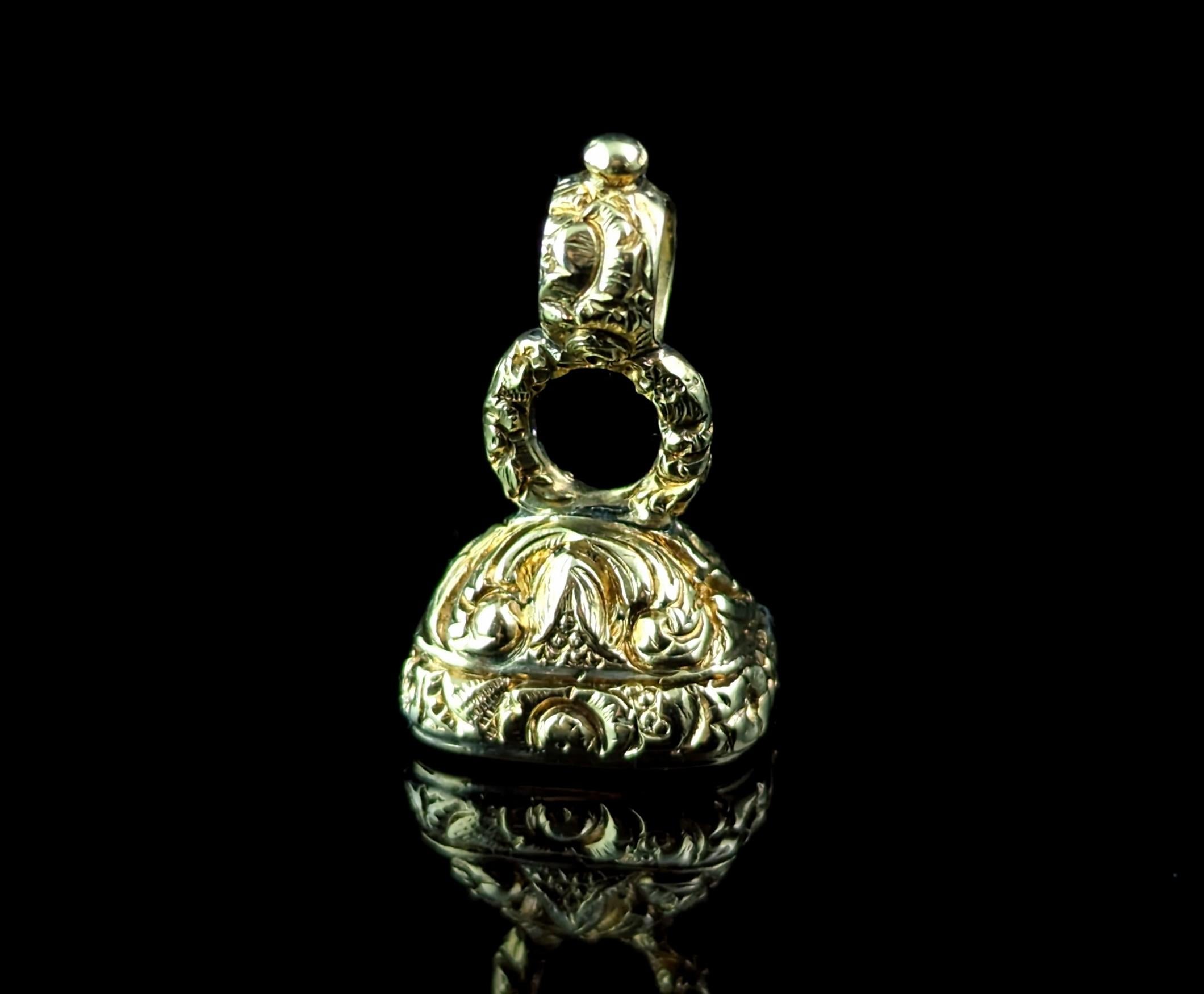 You can't go wrong with a beautiful antique seal fob, this sweet antique, Georgian era, gold cased seal fob is a real versatile beauty.

Made from rich 9ct yellow gold cased metal, it is has an elaborate engraved and chased design with floral