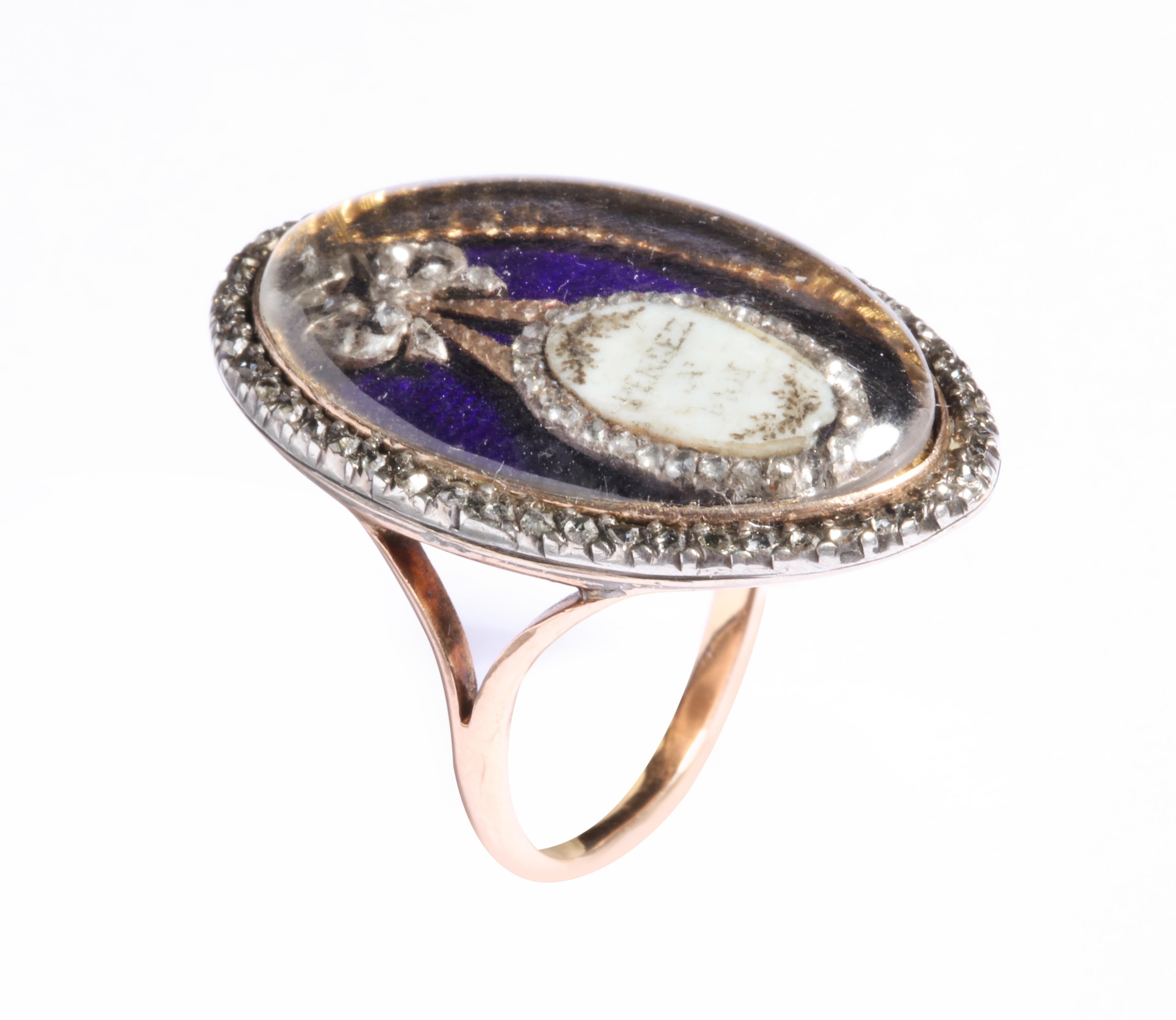 Diamonds shine under crystal where they surround an enamel mirror. Under the crystal a blue enamel background is painted with a white mTwinkling small lights of antique cut rose diamonds frame this Georgian ring, and irror that hangs by a diamond