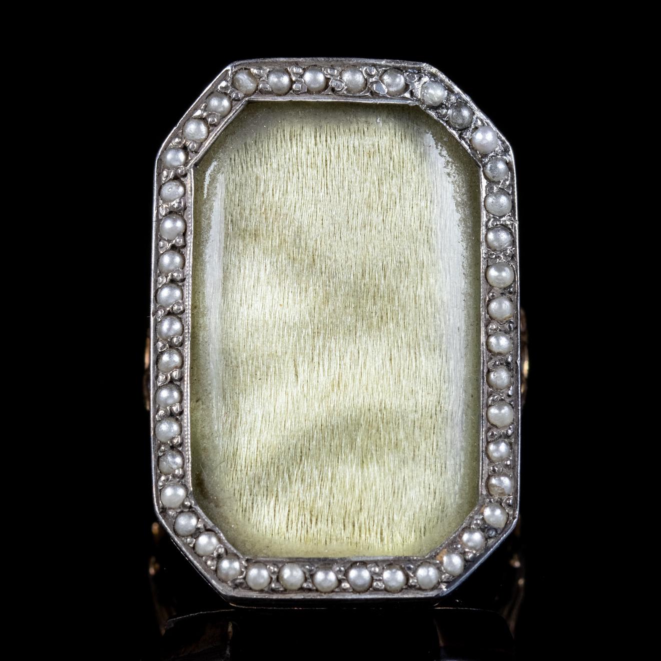 This wonderful antique Georgian mourning ring is all original from the 18th Century and features a large front gallery layered with a fine piece of golden silk that shimmers beautifully behind a protective glass window framed with Pearls. 

Mourning
