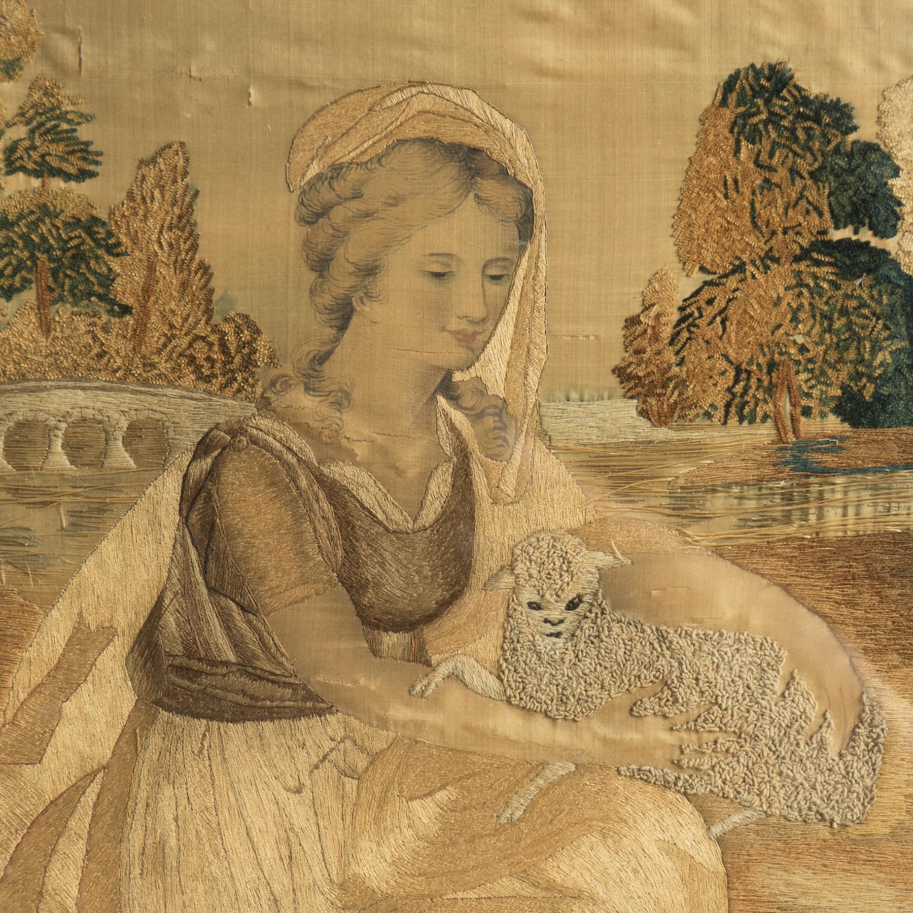 ANTIGUO BORDADO ORIGINAL DE SEDA E HILO DORADO DE GEORGE III

Una encantadora representación de una joven que sostiene un cordero en un paisaje.

El artista ha utilizado expertamente diferentes técnicas. El rostro de la mujer está pintado a mano