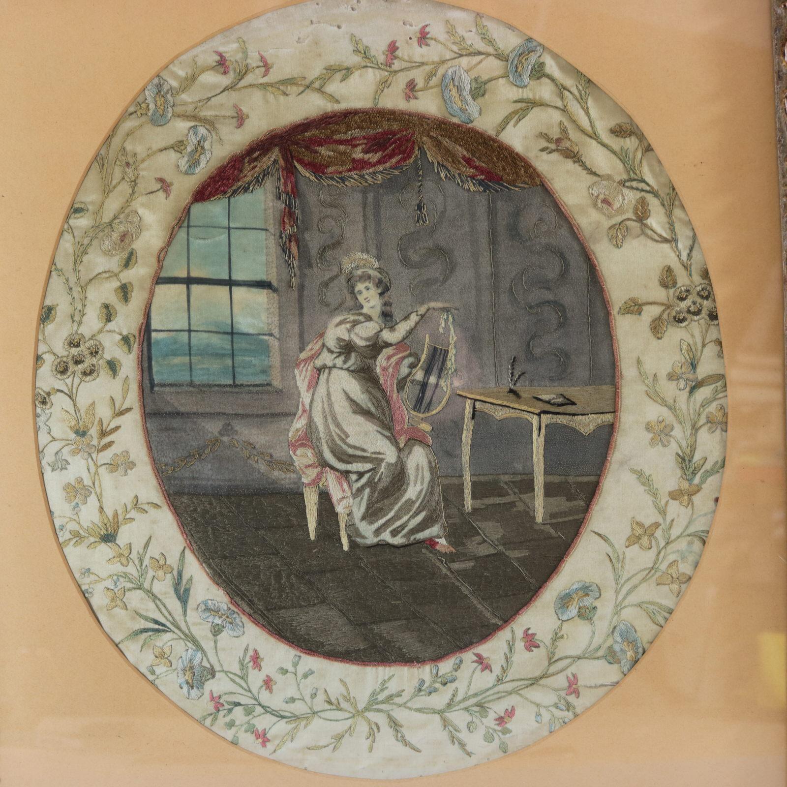 Antique Georgian silkwork embroidery depicting a young lady sitting in a room, gazing out the window. She is playing a lyre which rests on her lap. The embroidery is worked in silk, on a silk ground, in a variety of stitches. Colours brown, pink,