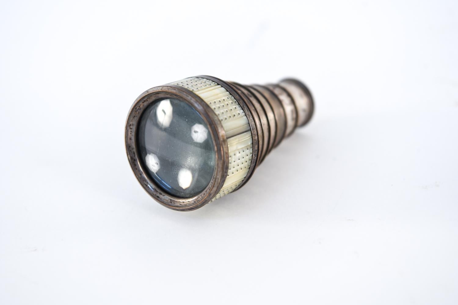 This miniature spyglass - also called a monocular pocket telescope - dates to the early 19th century and features lovely silver-beaded mother of pearl inlay. Case unscrews below 4th and 7th draws for cleaning and lens replacement. Apparently