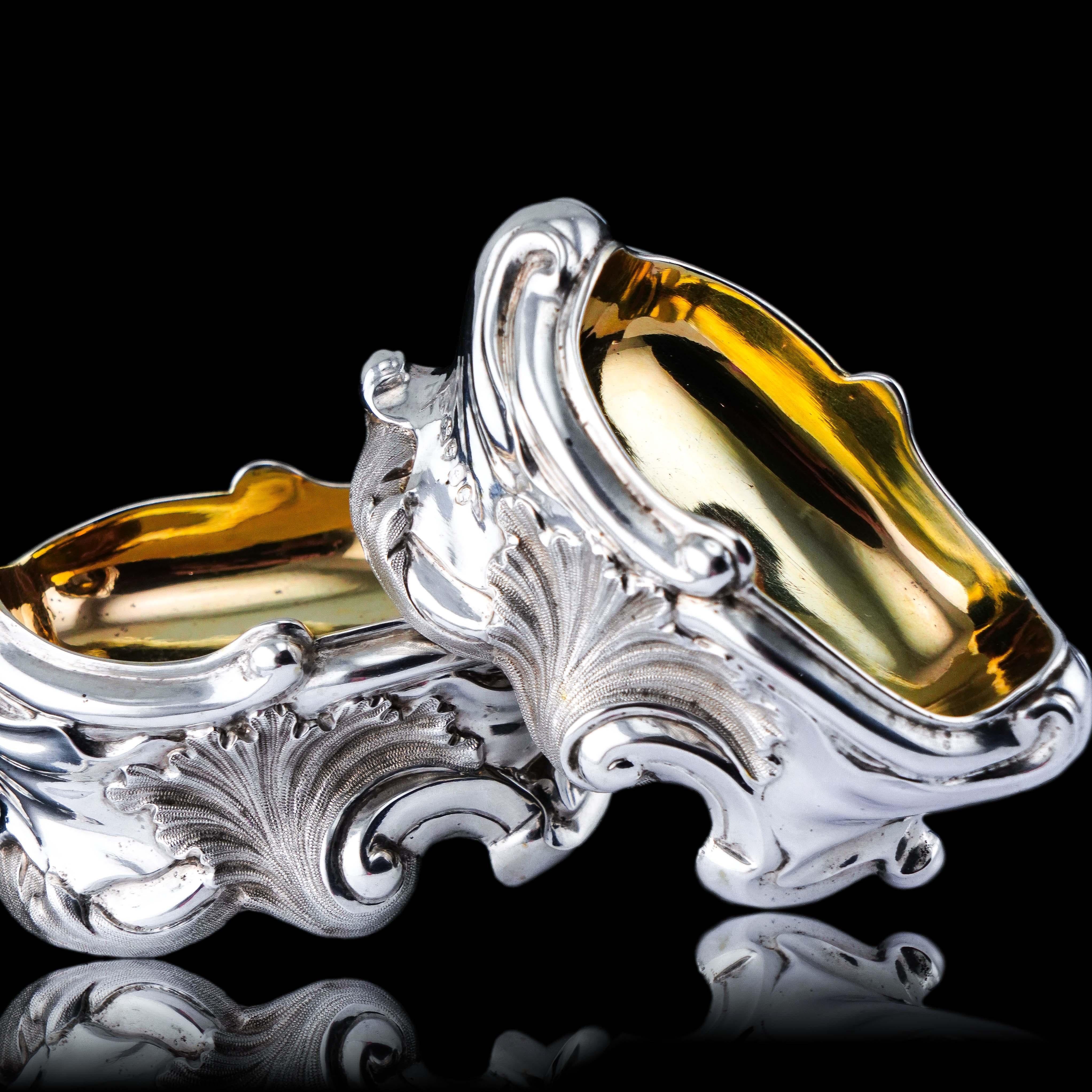 Nous sommes ravis de vous proposer cette magnifique paire de sels en argent massif fabriqués à Londres en 1834. 

La paire présente un design fluide et ouvert exceptionnel, avec une forme irrégulière, des bords en volutes et une feuille d'acanthe