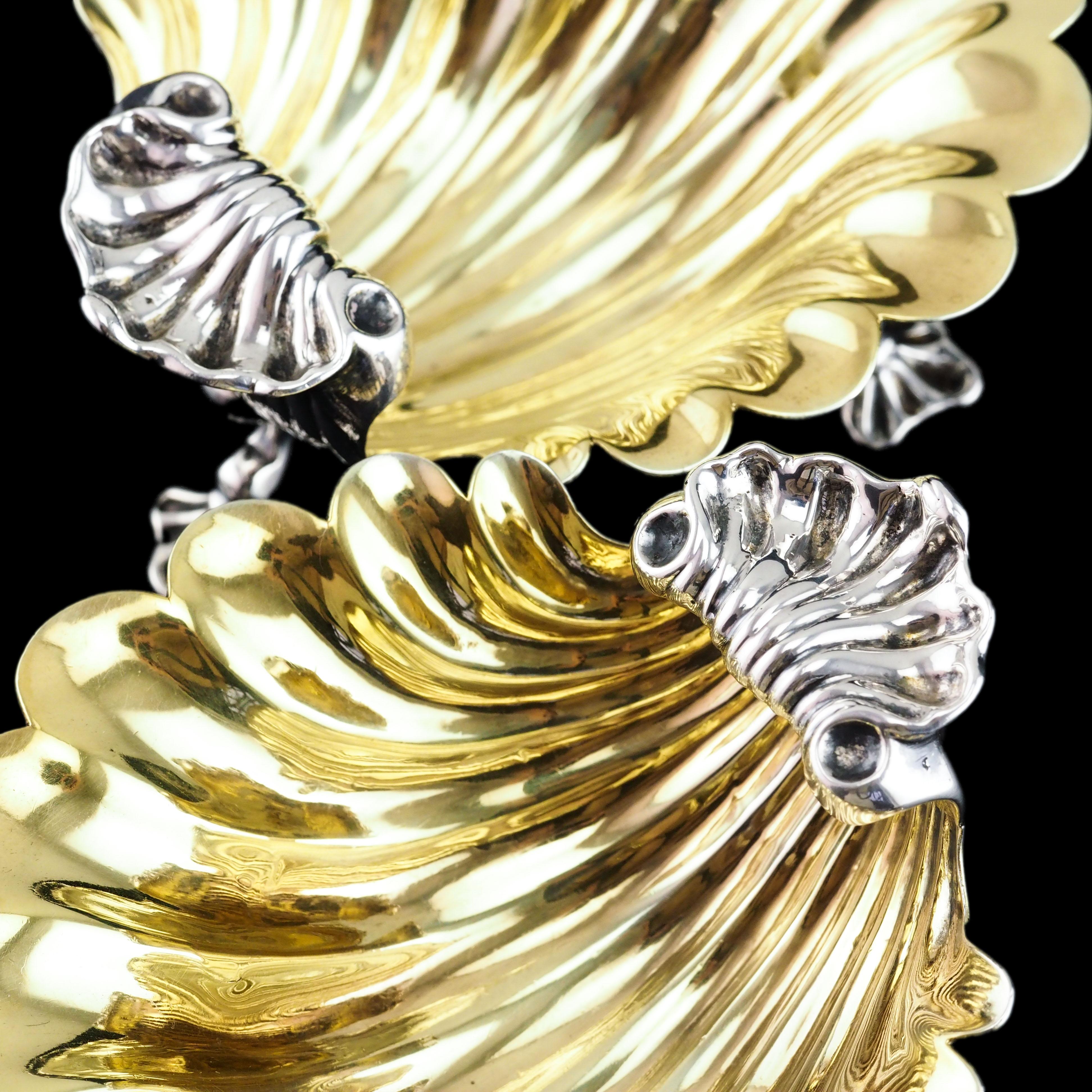 We are delighted to offer this stunning pair of antique Georgian Rococo solid silver shell salt/butter made in London 1755 with marks of Samuel Herbert & Co..

Delightfully sculpted in scallop shell form with three supporting cast feet, these shell