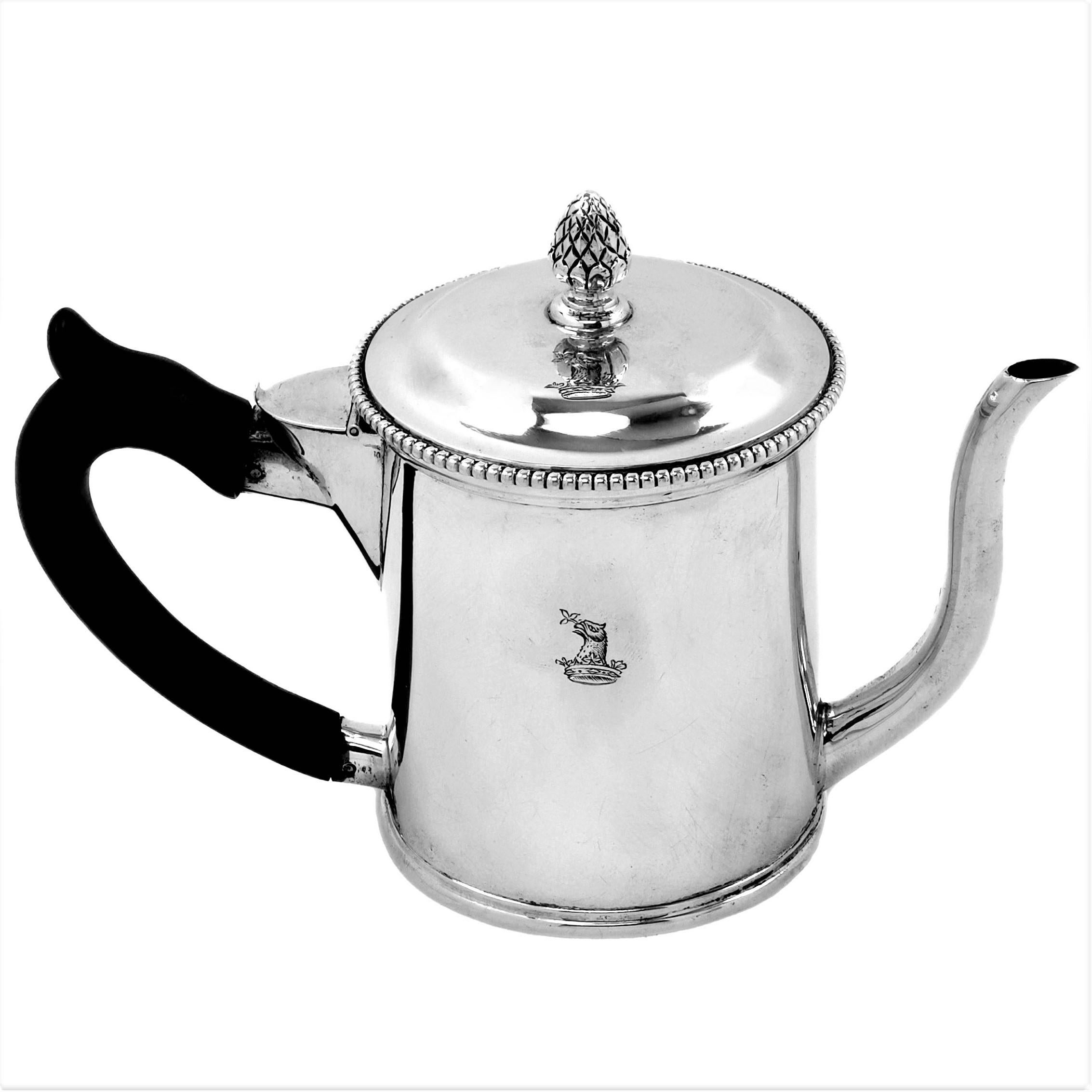 A fine antique George III Sterling Silver Argyle with an elegant straight sided design. The Lid of the Gravy / Sauce Argyle has a beaded rim and an decorative finial. This 18th century Argyle has a wooden handle and a small crest engraved on the
