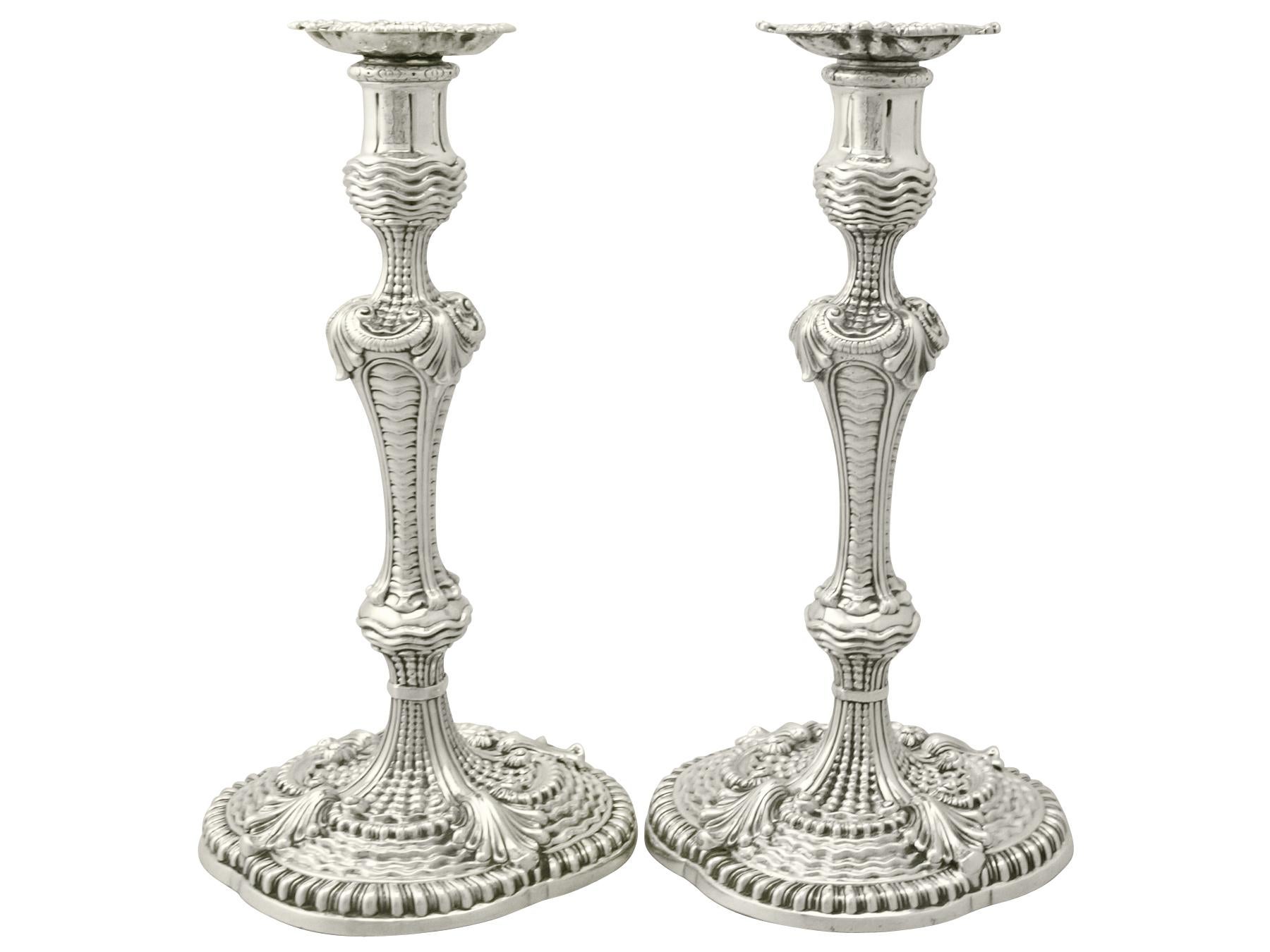 A magnificent, fine and unusual pair of antique Georgian English cast sterling silver candlesticks; an addition of our ornamental silverware collection.

These magnificent antique George II cast sterling silver candlesticks have a baluster shaped