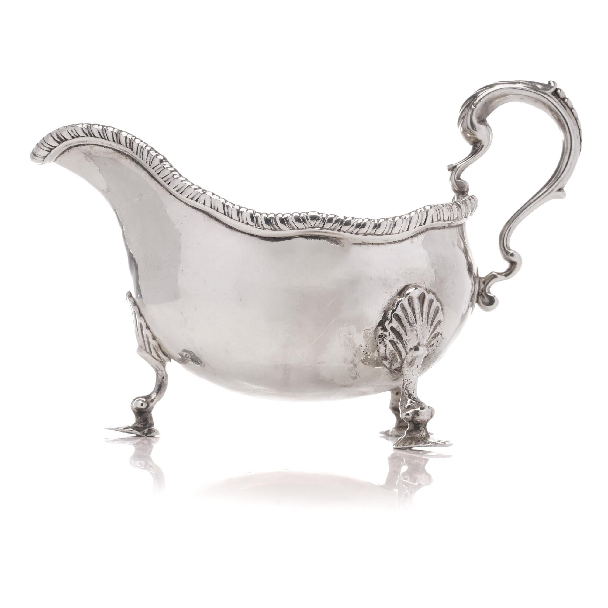 British Antique Georgian sterling silver chased sauce boat with elaborate decorations For Sale