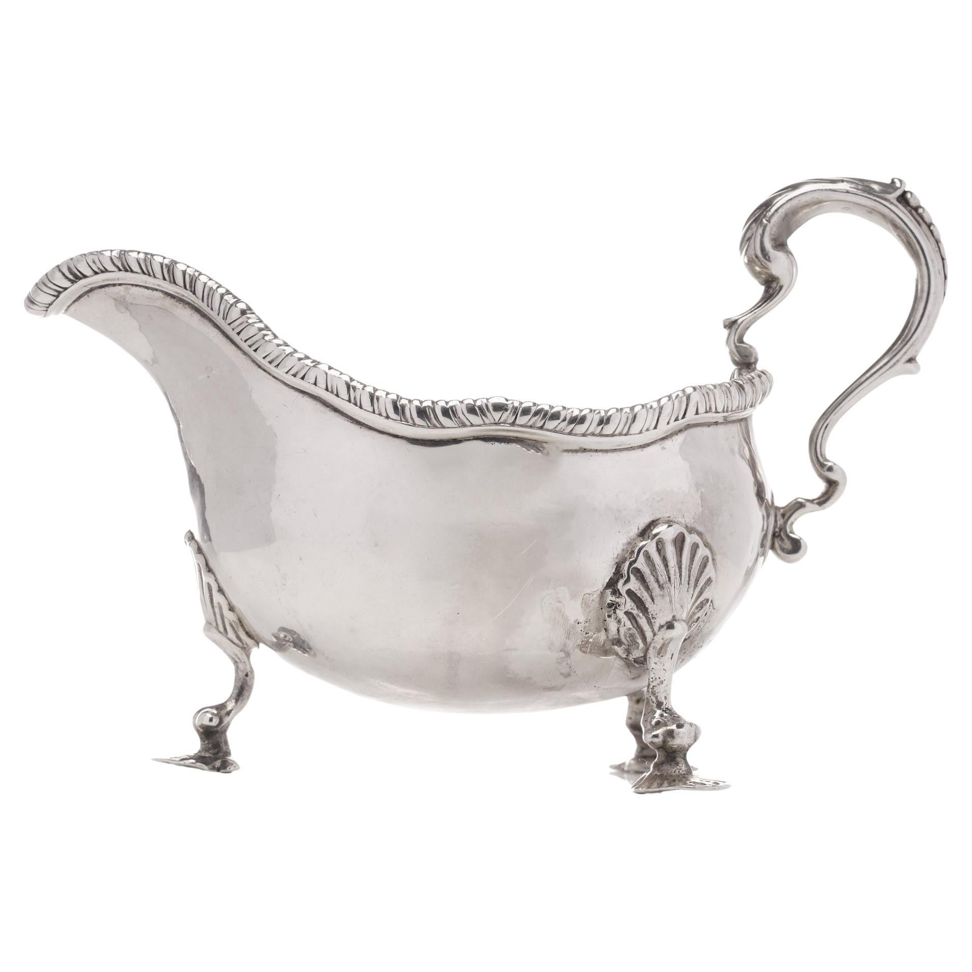 Antique Georgian sterling silver chased sauce boat with elaborate decorations For Sale