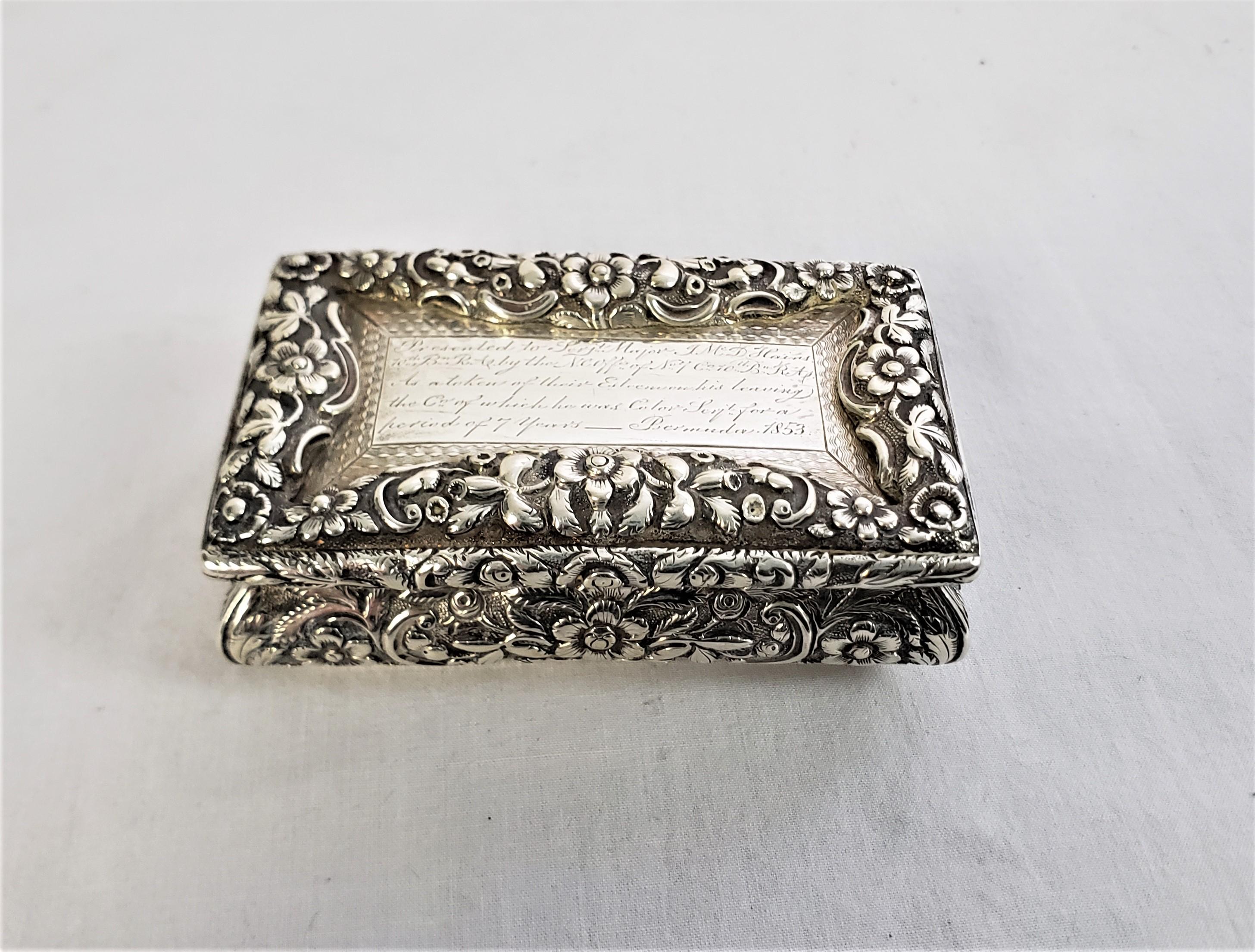 This antique snuff or tobacco box is hallmarked by an unknown maker, and originates from England and dates to 1820 and done in the period Georgian style. The box is engraved in script on the top panel and was presented to Sgt. Major Hains in 1853 in