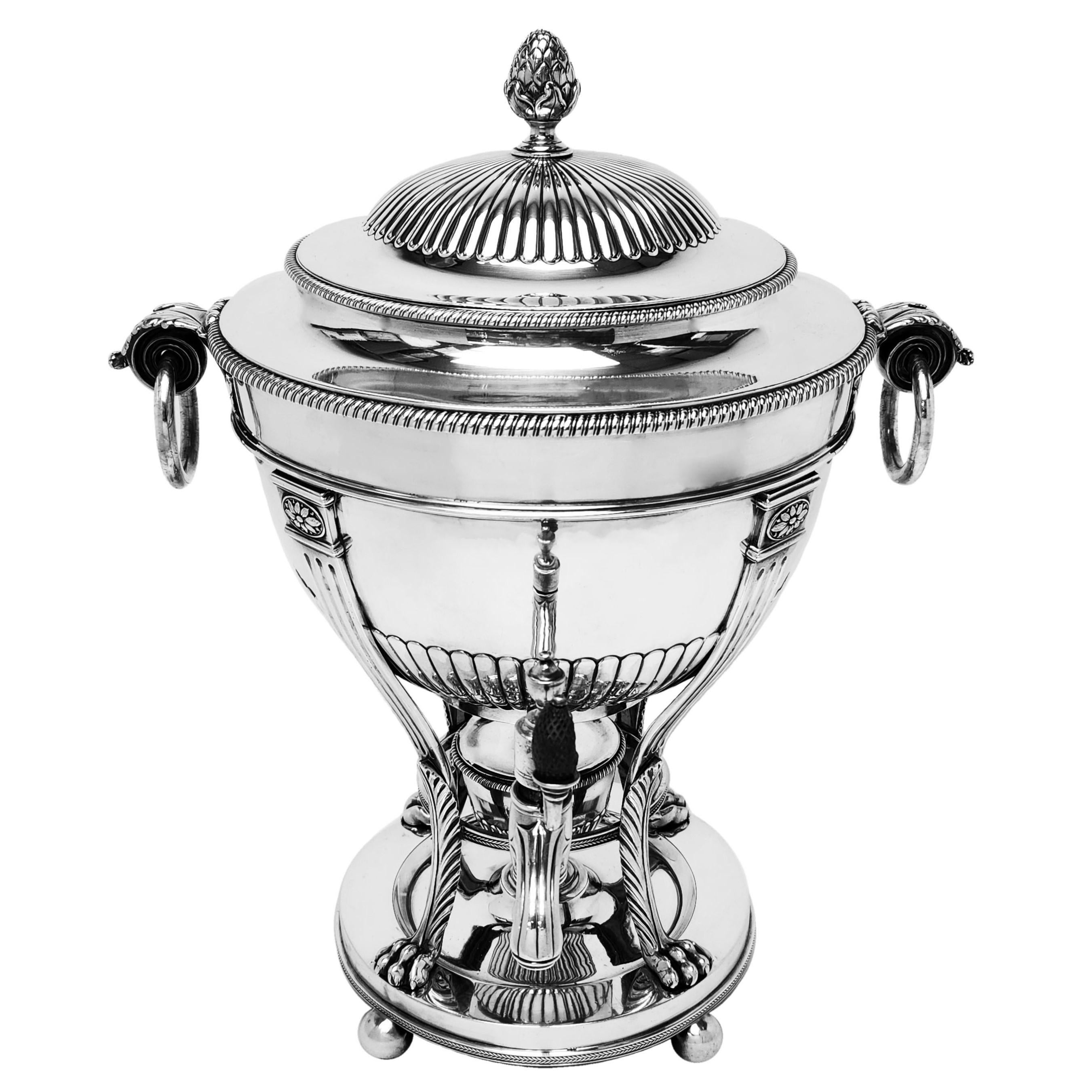 A magnificent Antique George III Sterling Silver Samovar by esteemed silversmith Paul Storr. This Georgian Tea Urn boasts many design elements typical of Storrs classical style. The round Urn is supported on 4 leaf topped lion paw feet and the body