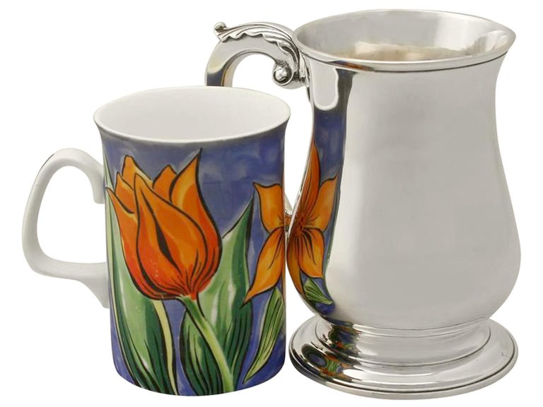 An exceptional, fine and impressive antique George III English sterling silver pint mug; an addition to our Georgian silverware collection.

This exceptional antique George III sterling silver pint mug has a plain baluster form onto a circular