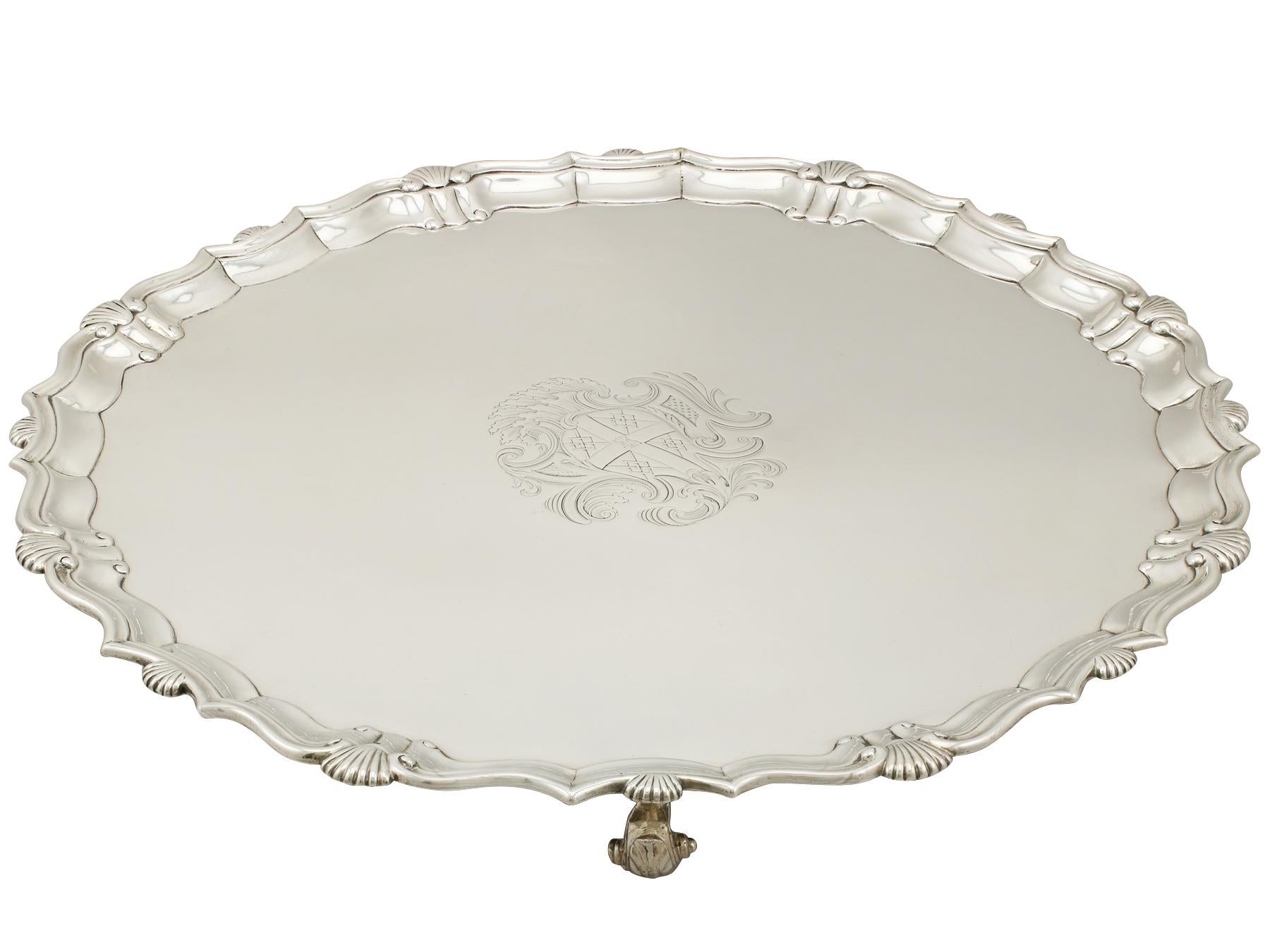 A fine and impressive, large antique Georgian English sterling silver salver made by John Tuite; an addition to our dining silverware collection.

This fine antique George II sterling silver salver has a plain circular shaped form.

The surface