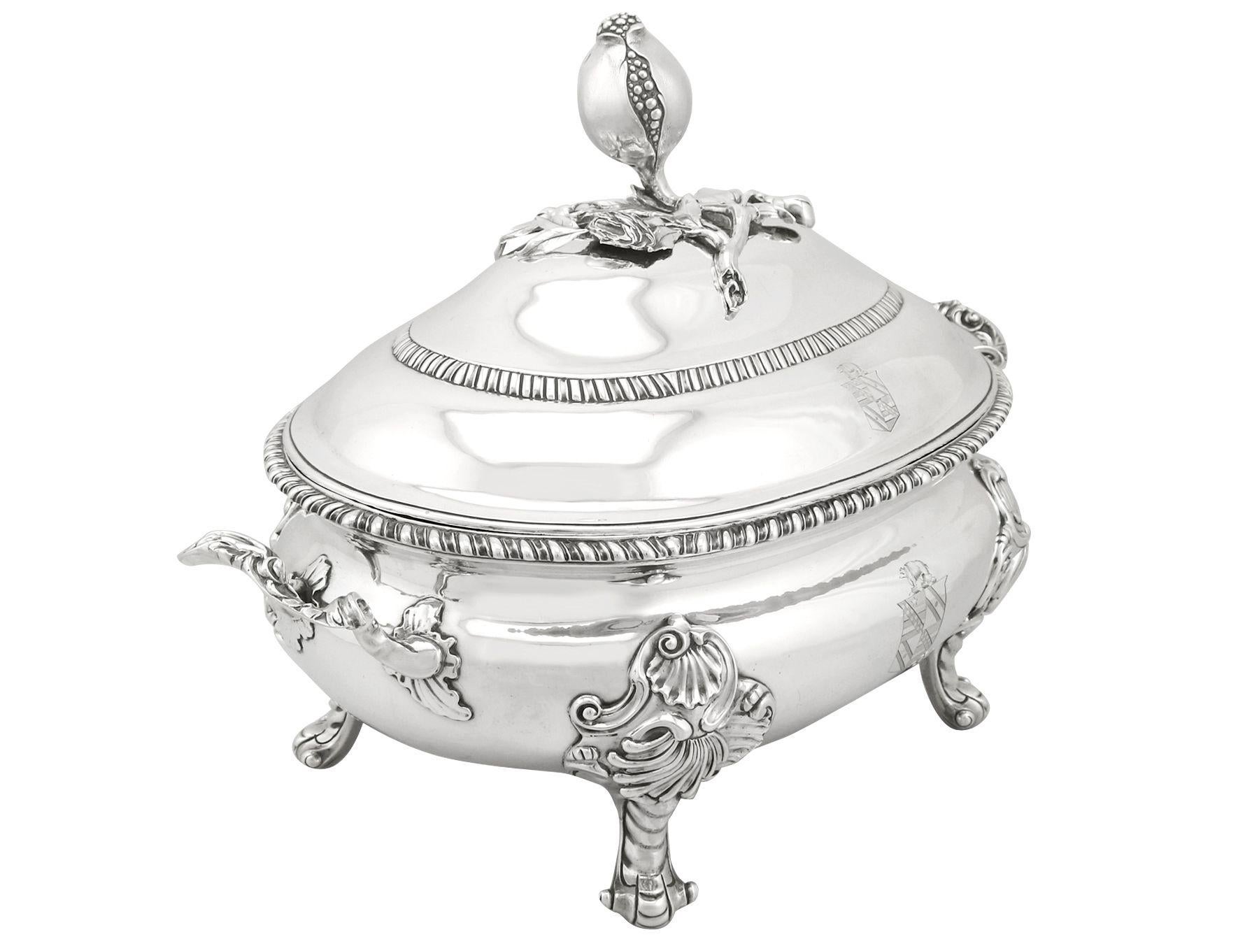 A magnificent, fine and impressive antique Georgian English sterling silver soup tureen; an addition to our collection of serving dishes.

This magnificent antique George II English sterling silver soup tureen has an oval rounded form.

The
