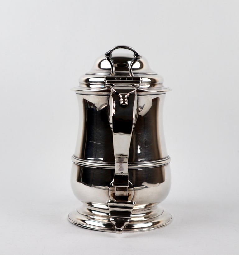 Magnificent Georgian 18th century lidded tankard of baluster form, with girdle and applied S-scroll handle with foliate thumb piece attached to a high domed cover.
Weight 954 grams.