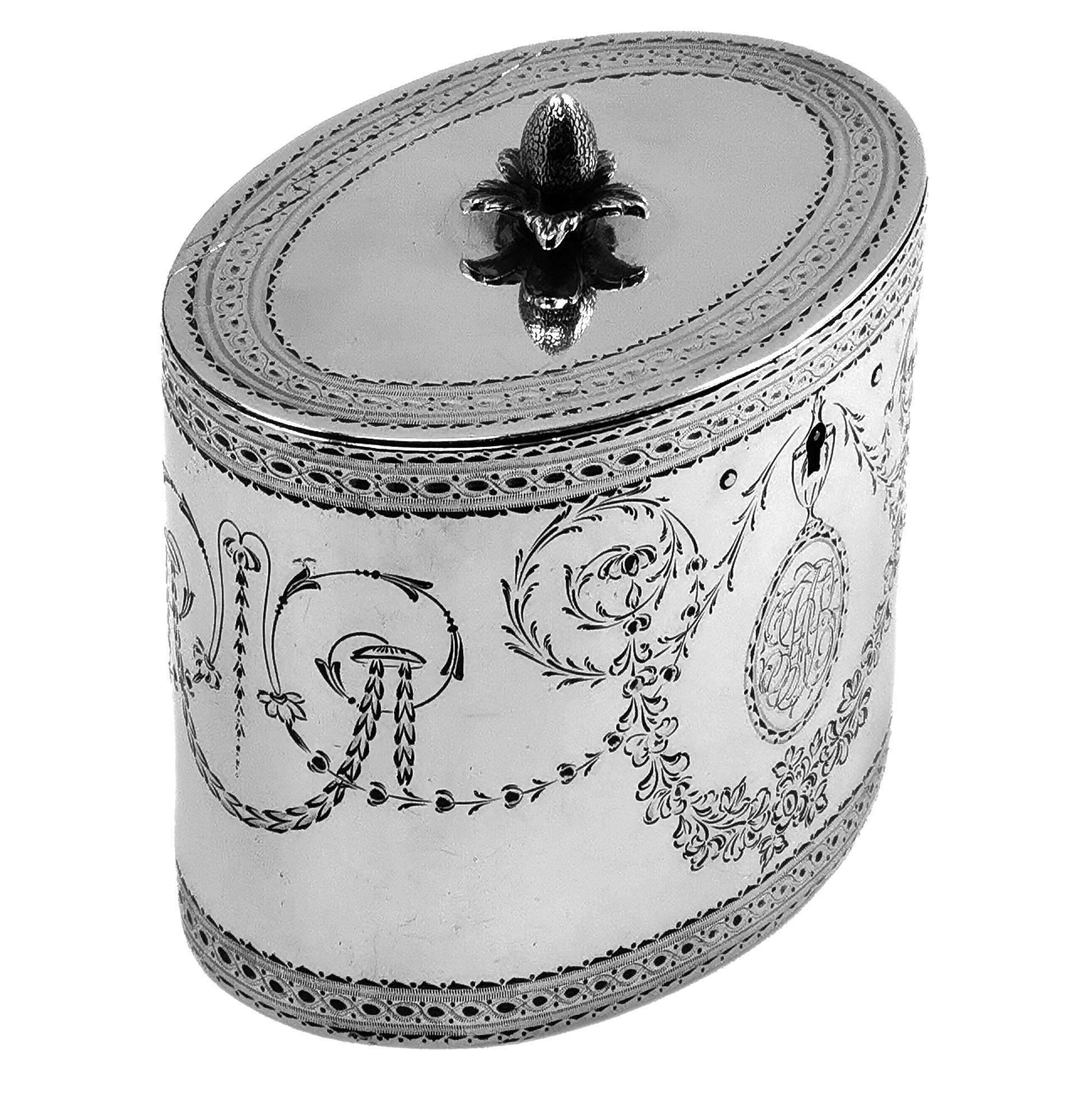An antique George III solid Silver Tea Caddy in a classic straight sided oval form. The Tea Caddy has an elegant engraved pattern on the sides and in the flat hinged lid. The Caddy has a pair of engraved monograms in oval cartouches.

Made in