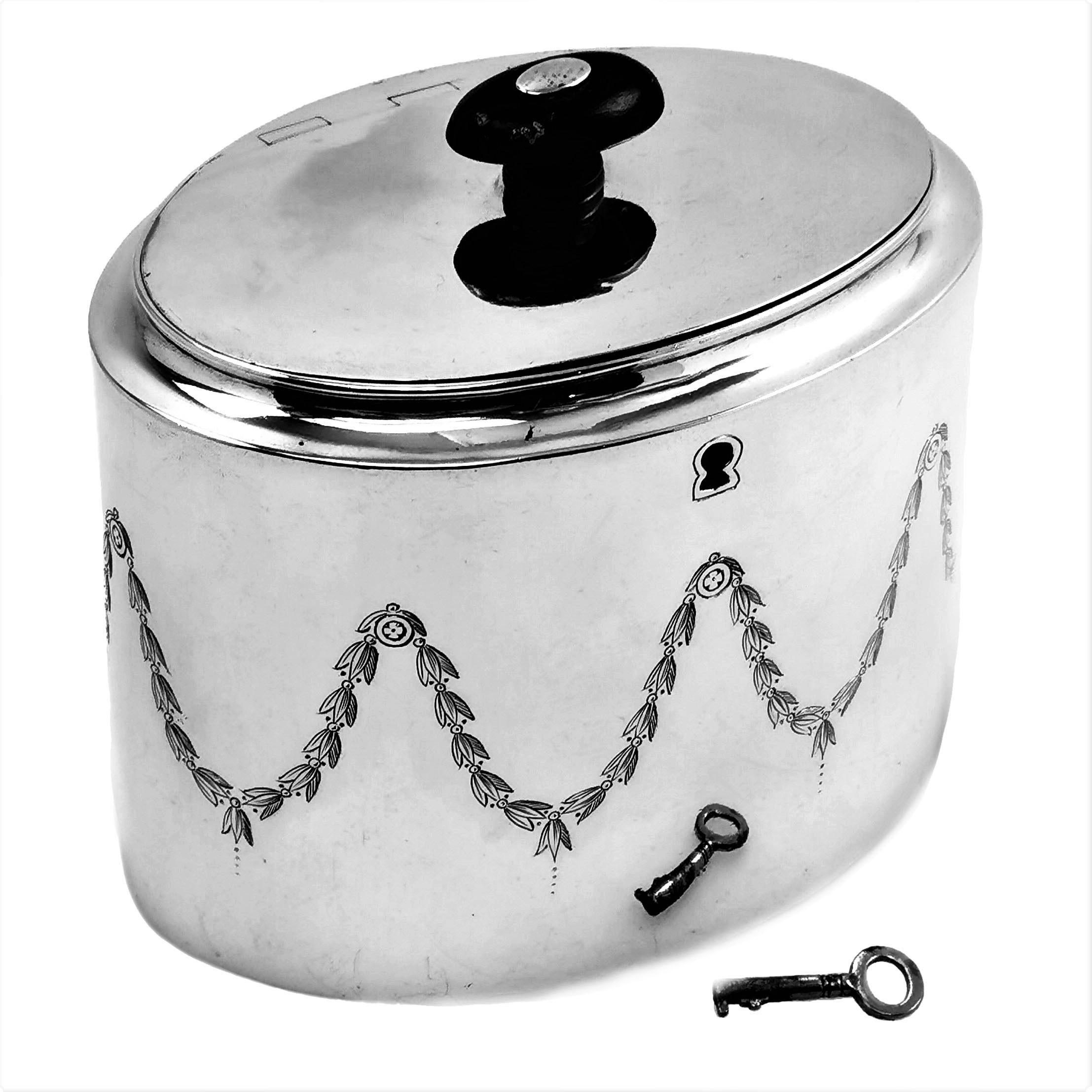 An Antique George III solid Silver Tea Caddy with an elegant engraved band of leaf swags around the body. 

Made in London, England by Abstinando King.

Approx. Weight - 394g / 12.67oz
Approx. Length - 13.1cm
Approx. Width - 9.3cm
Approx. Height -