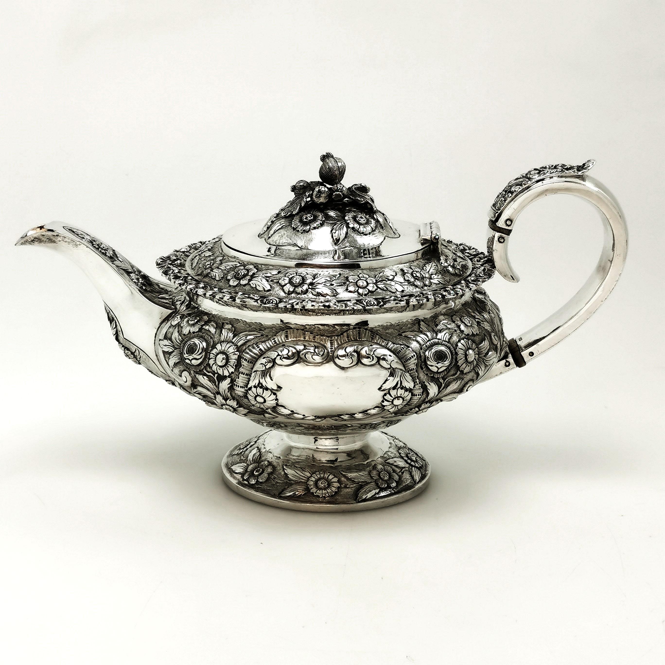 A lovely antique George IV solid Silver Teapot featuring an ornate chased floral design on the body, foot and lid. The handle and spout are further embellished with matching chased designs and the Lid features an impressive complimentary finial. The